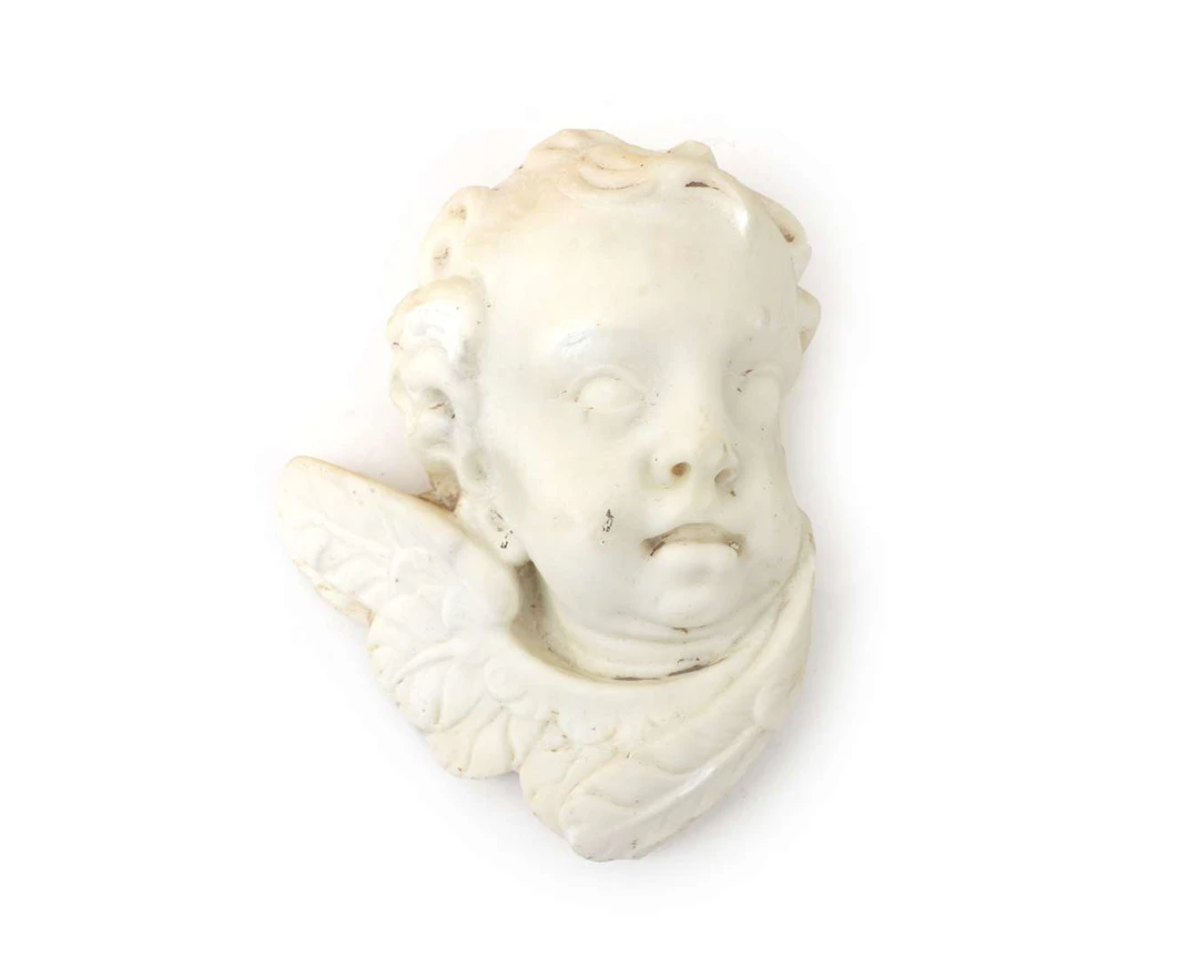 An alabaster bust of a putto, 20th century