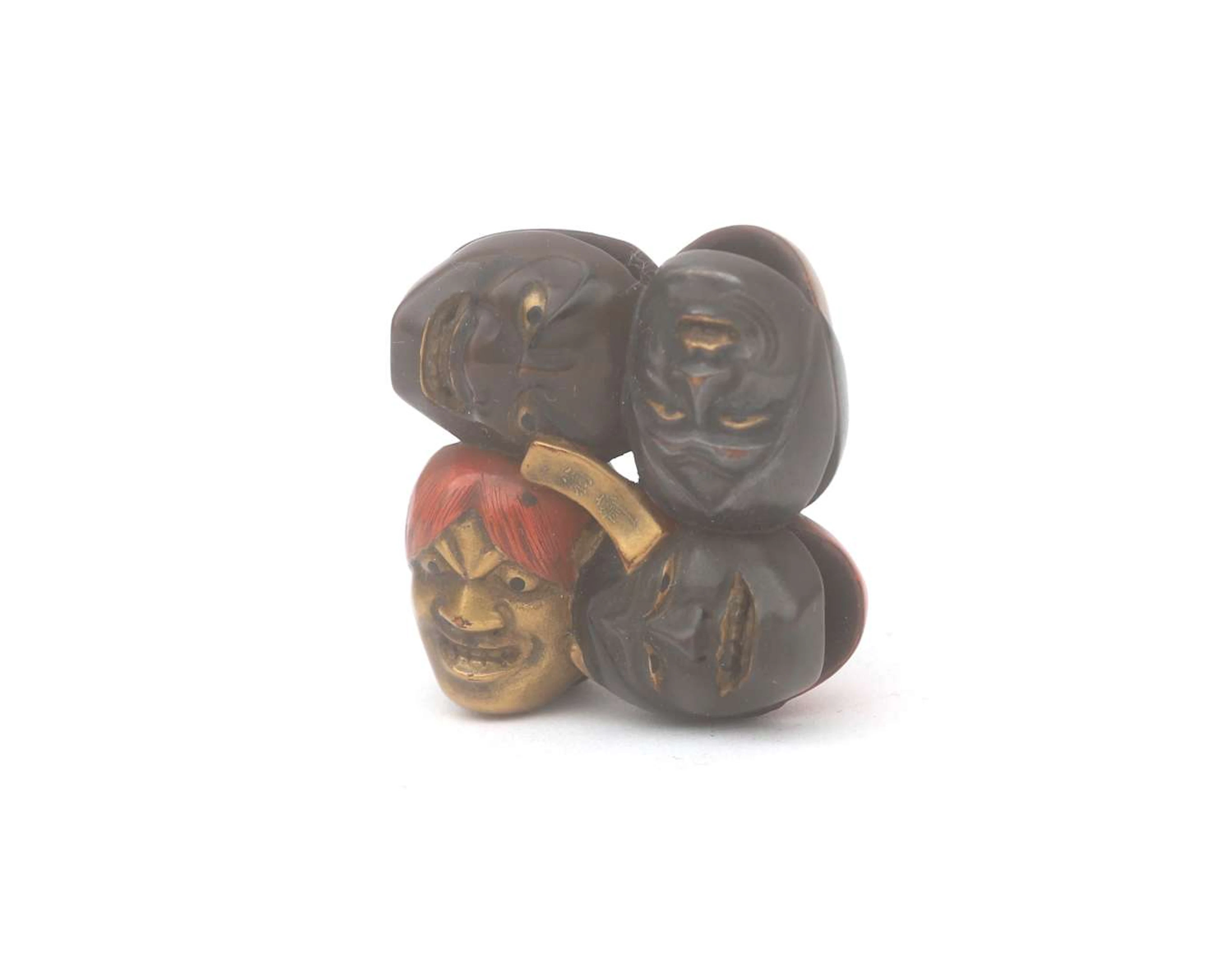 A netsuke and sagemono of tattered masks, Japan, 19th century