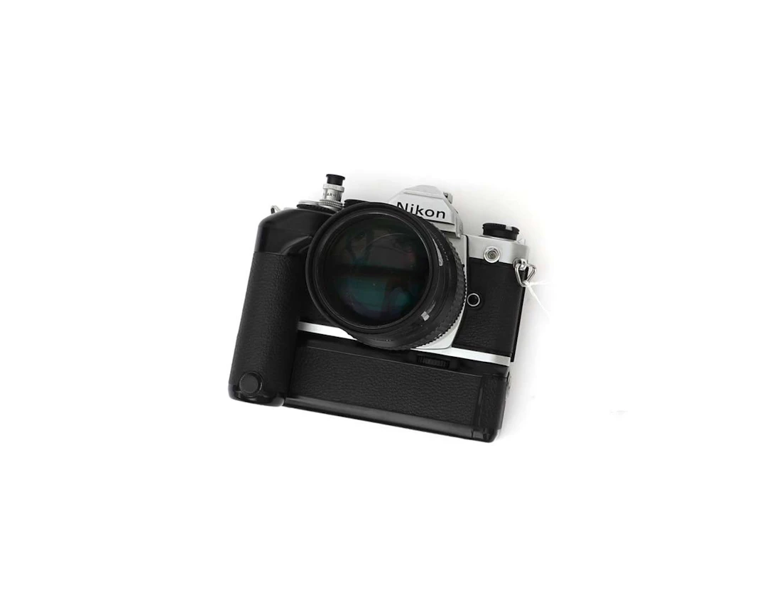 A Nikon FM with a Nikkor 1:4 F 200 mm lens and MD-11 grip