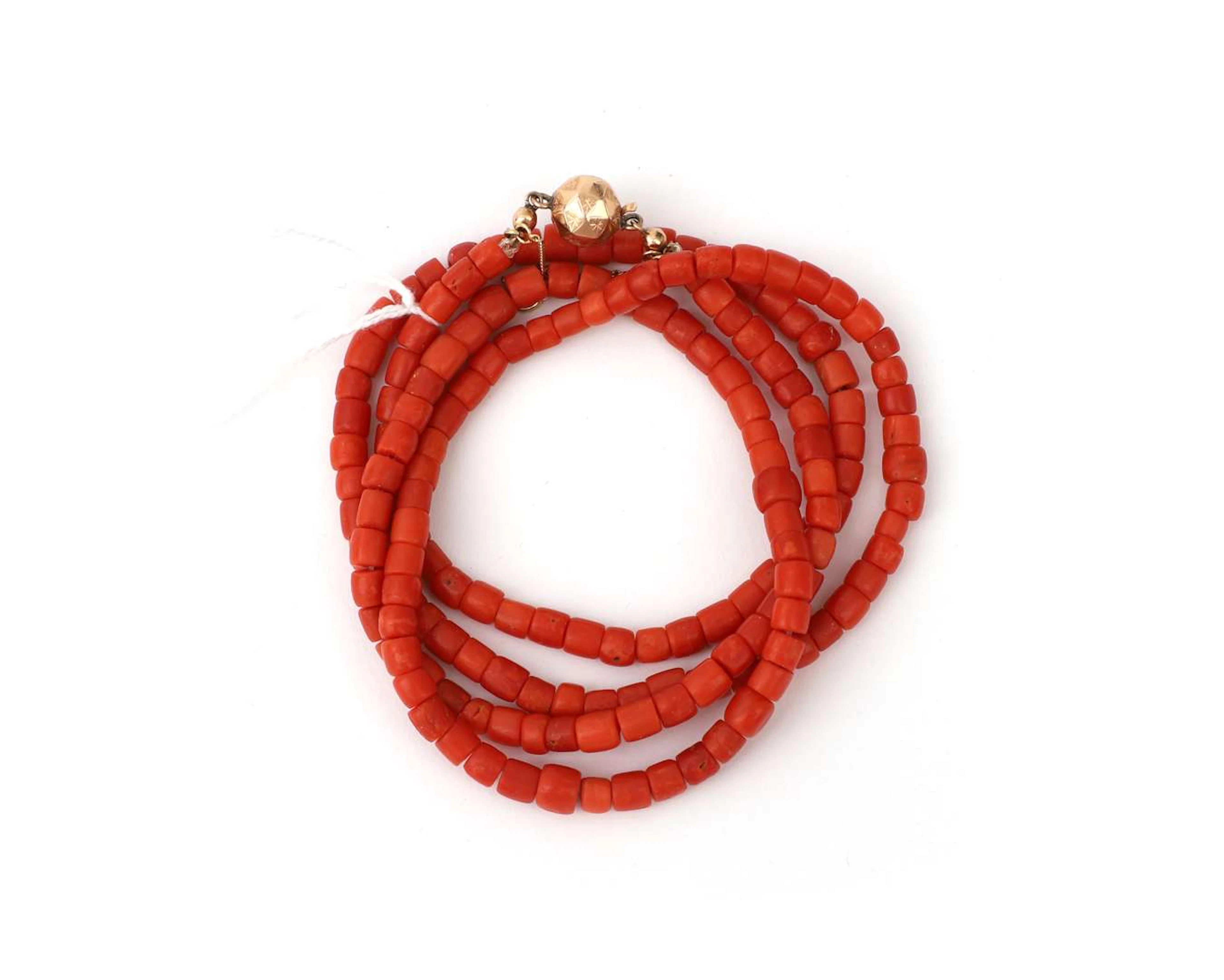 A red coral necklace with a 14k rose gold ball clasp