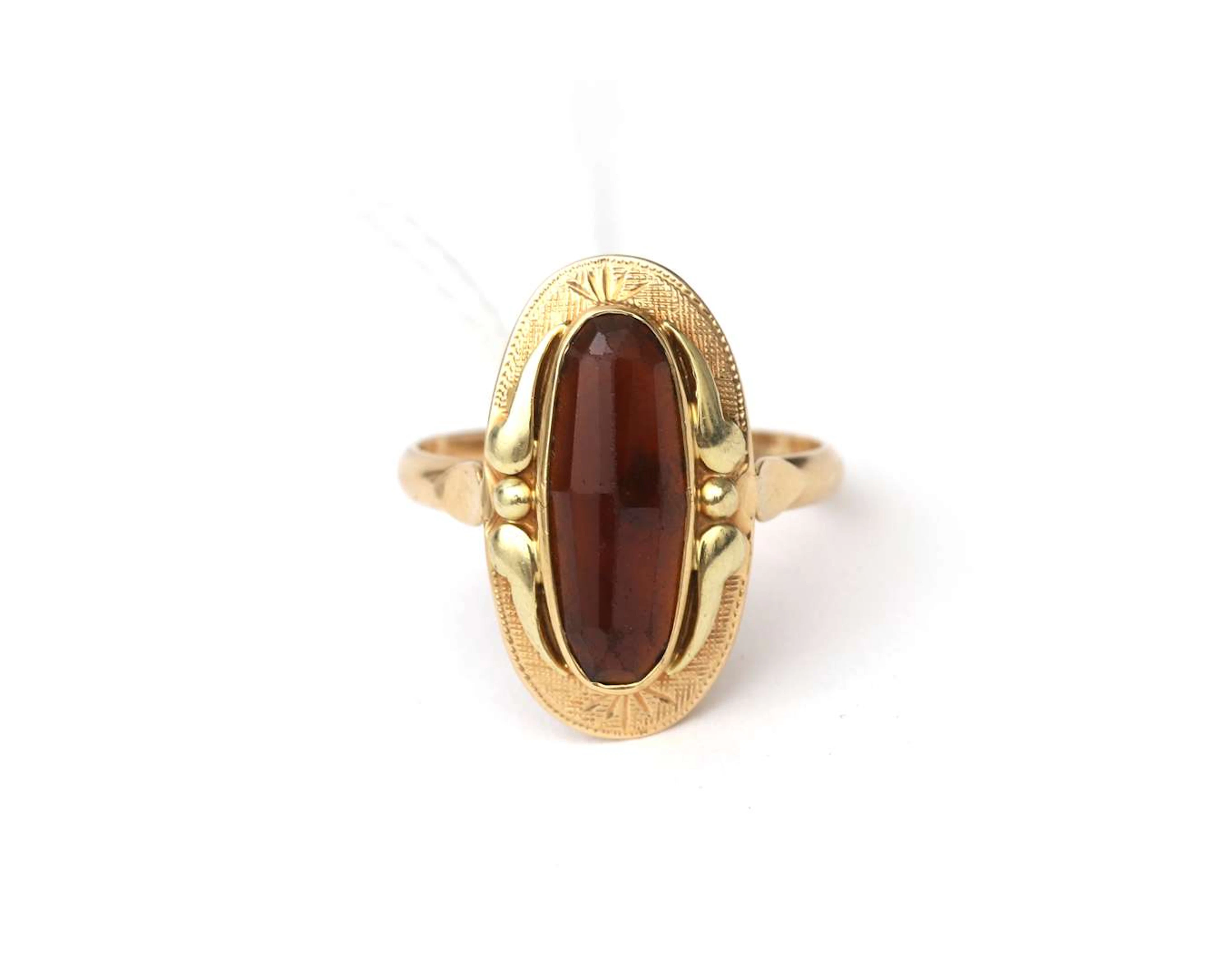 A 14k yellow gold ring with garnet