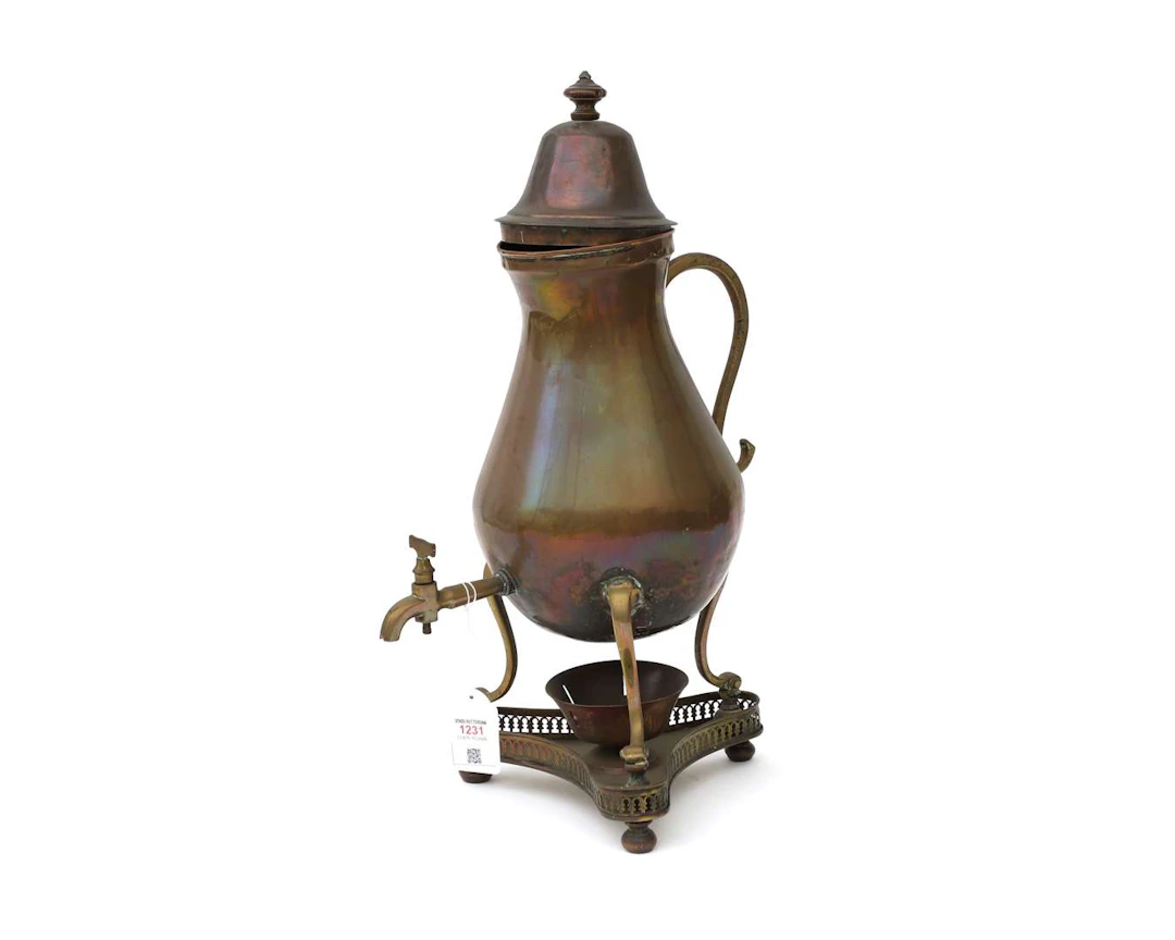 A copper jug with a tap, circa 1900
