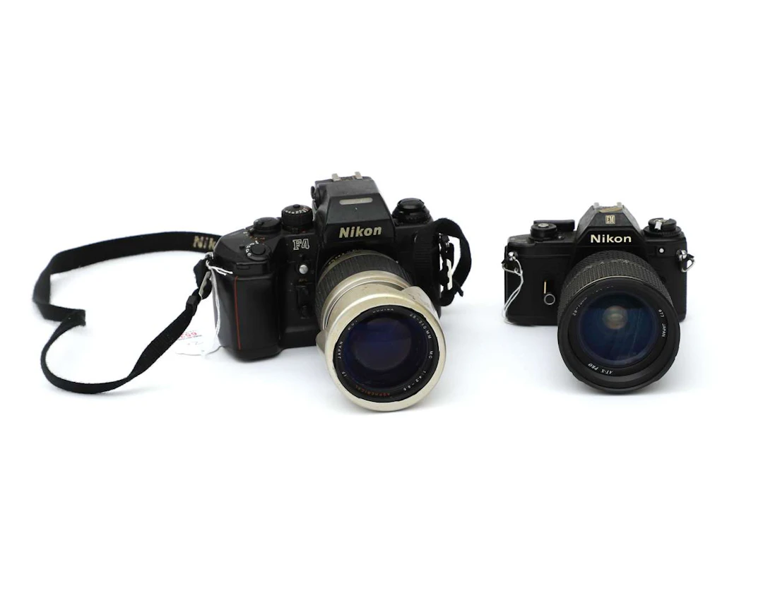A Nikon F4 and a Nikon EM camera with lenses