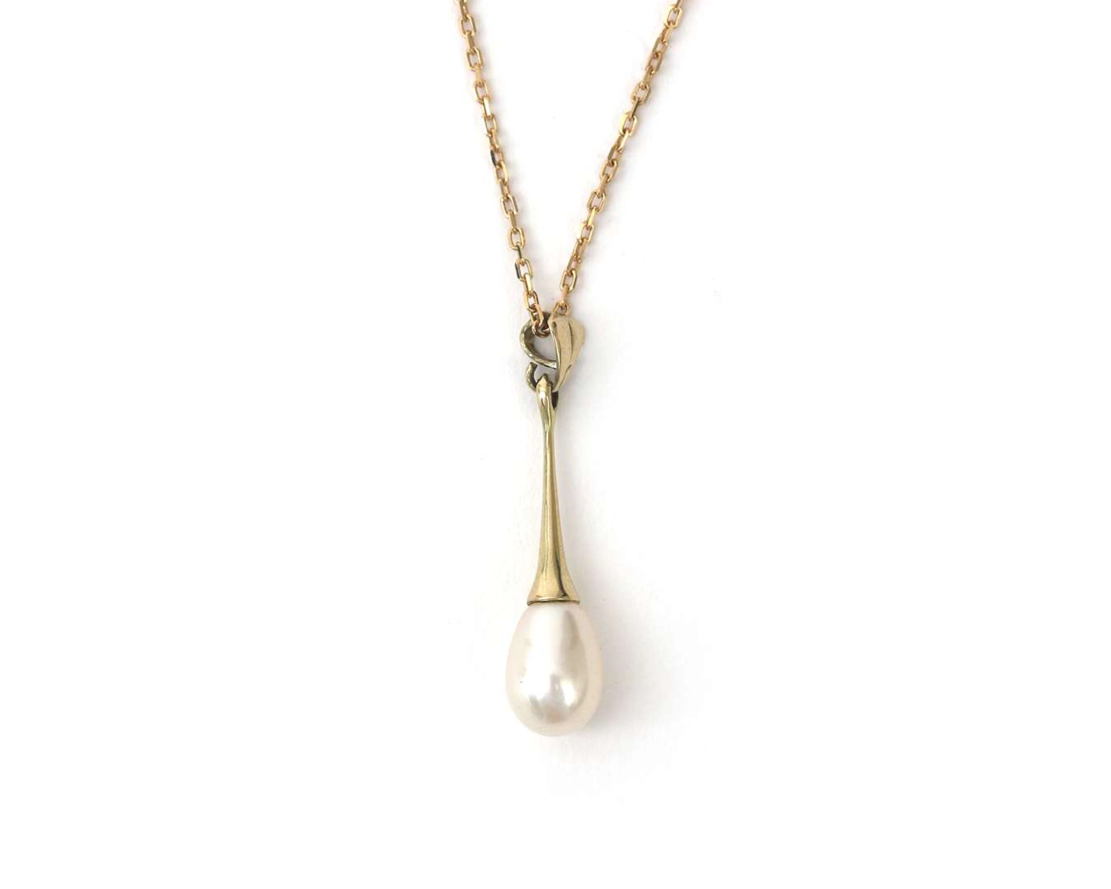 A 14k yellow gold necklace featuring a pendant with a teardrop-shaped pearl