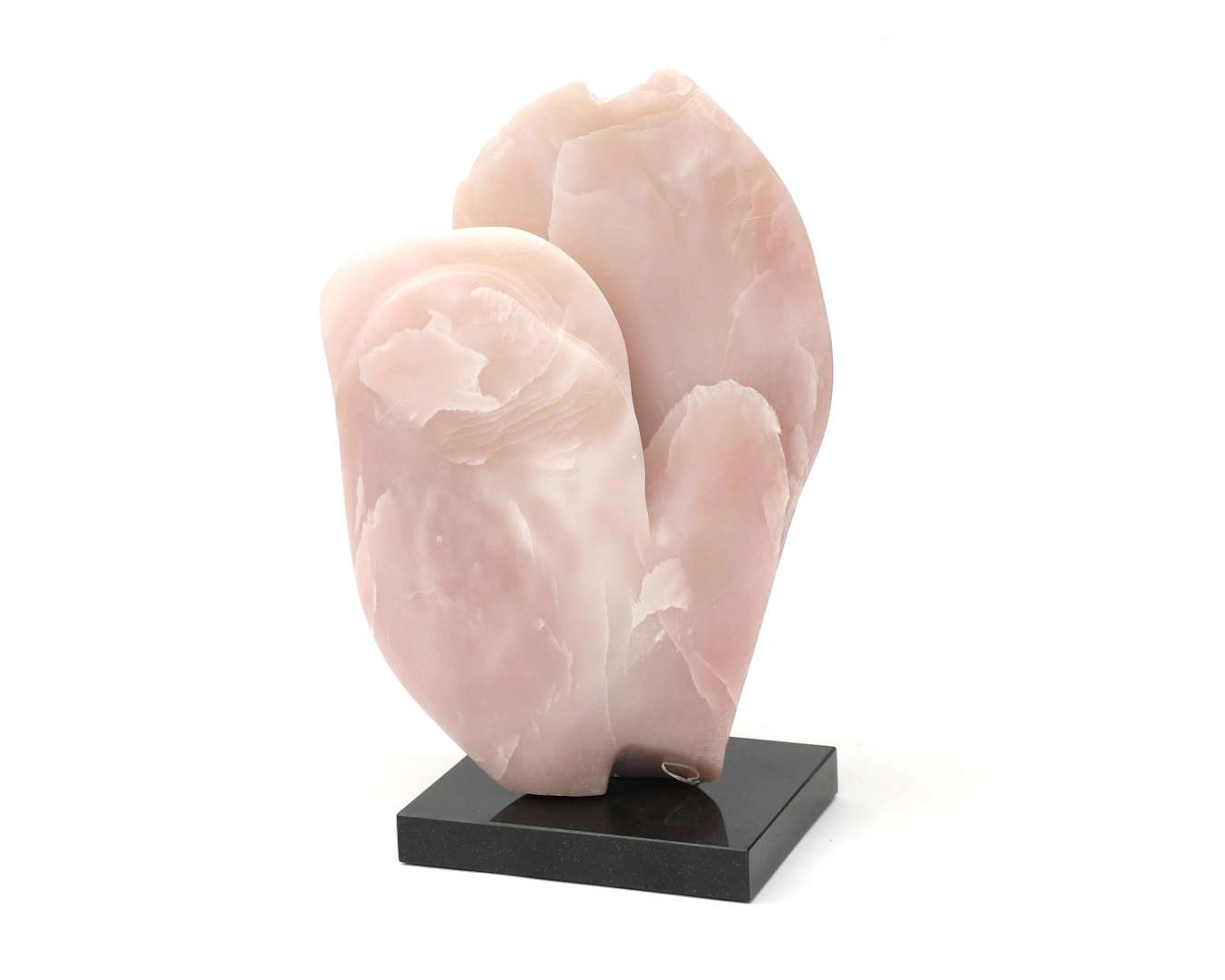 A rose quartz statue on a plinth
