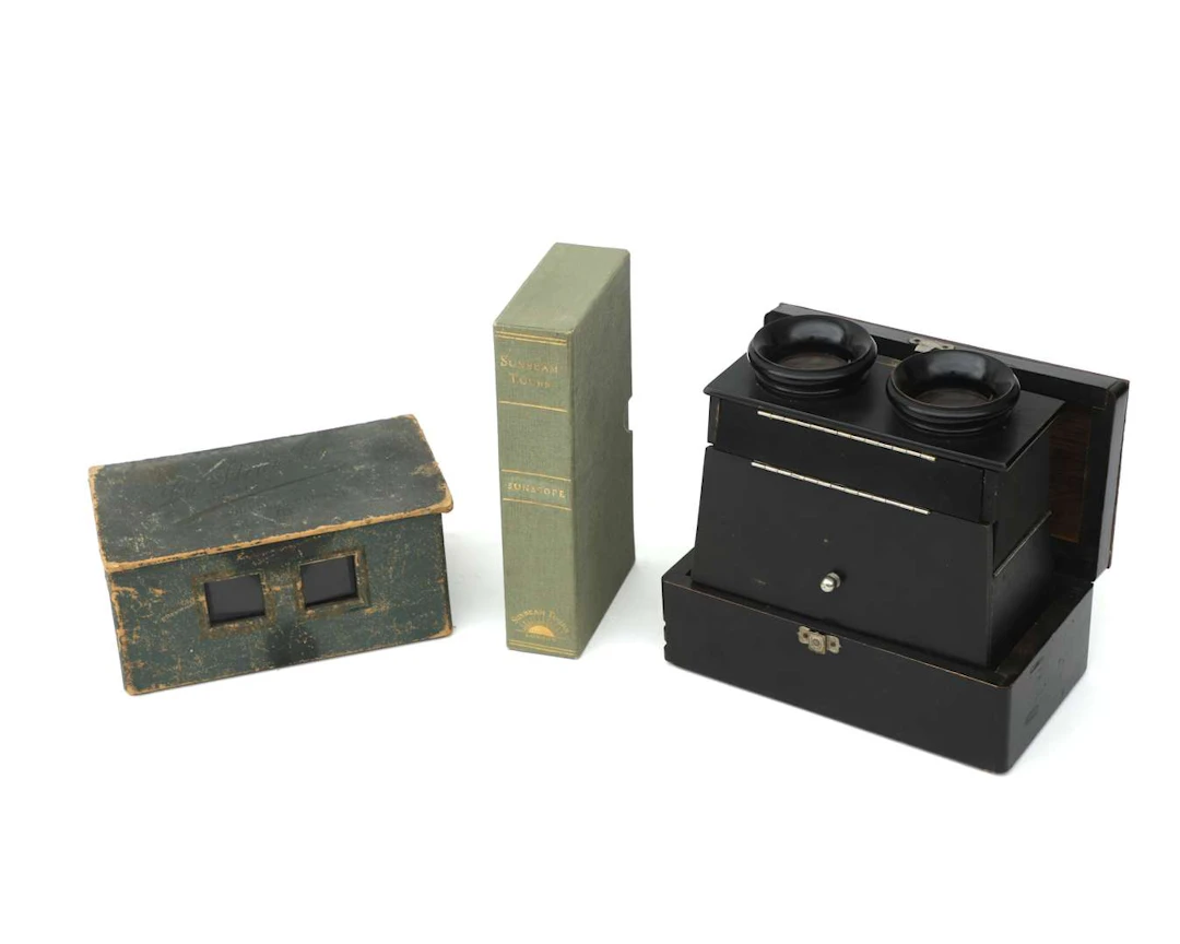 Two folding stereo viewers with stereo photographs, first quarter
