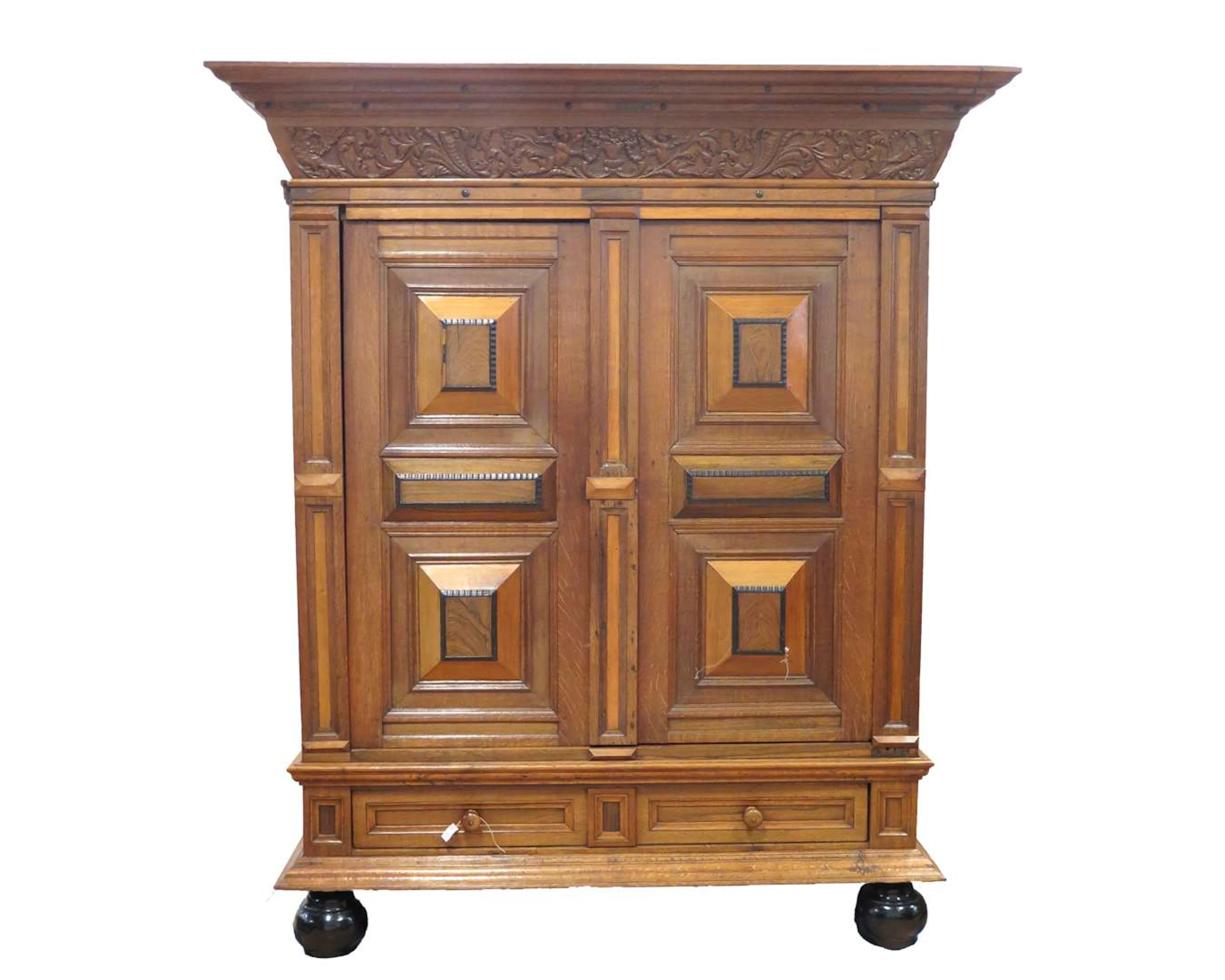 An oak cushion cabinet with a carved frieze. 19th/20th century