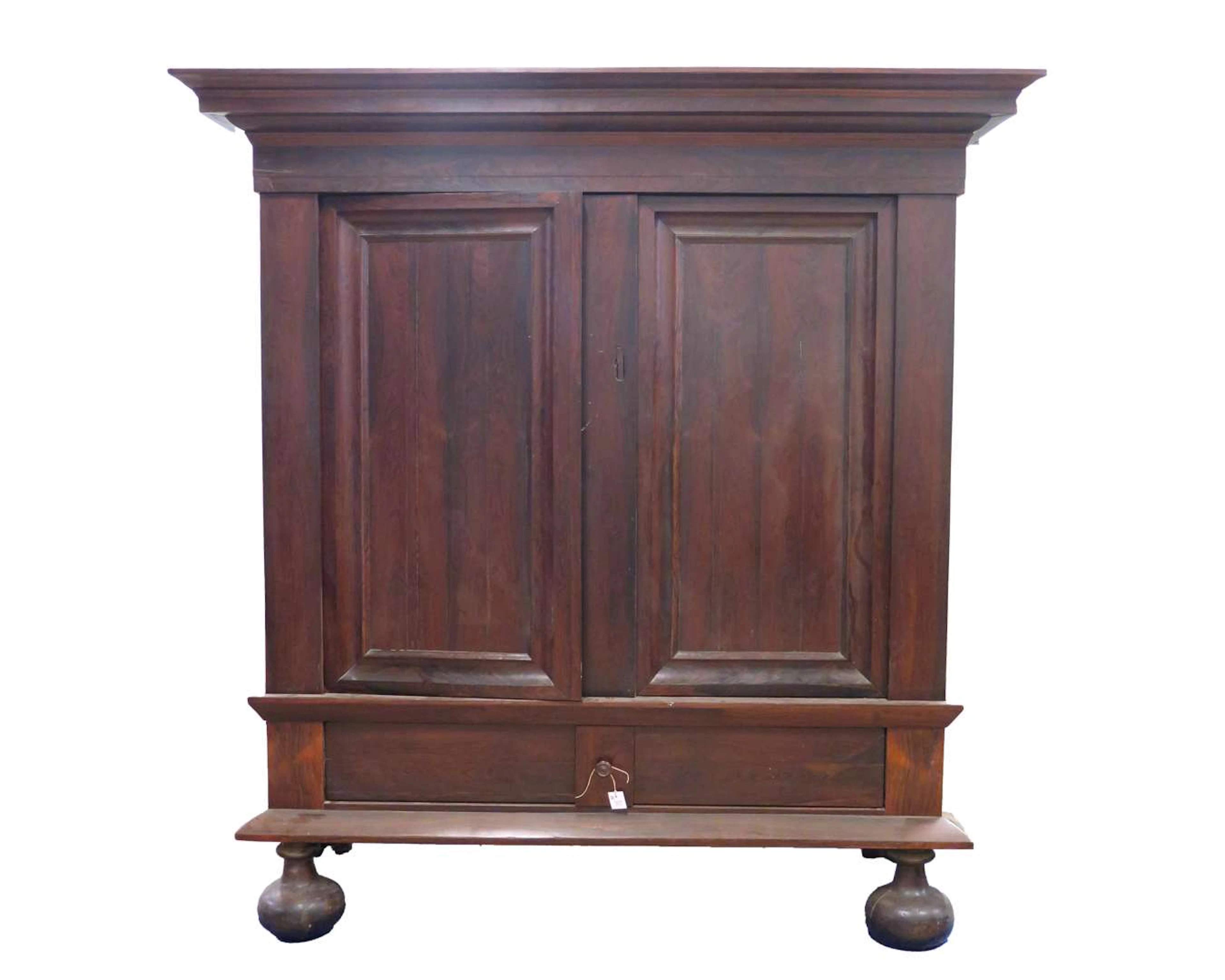 A two-door walnut cupboard on black ball-and-claw feet. 18th/19th century