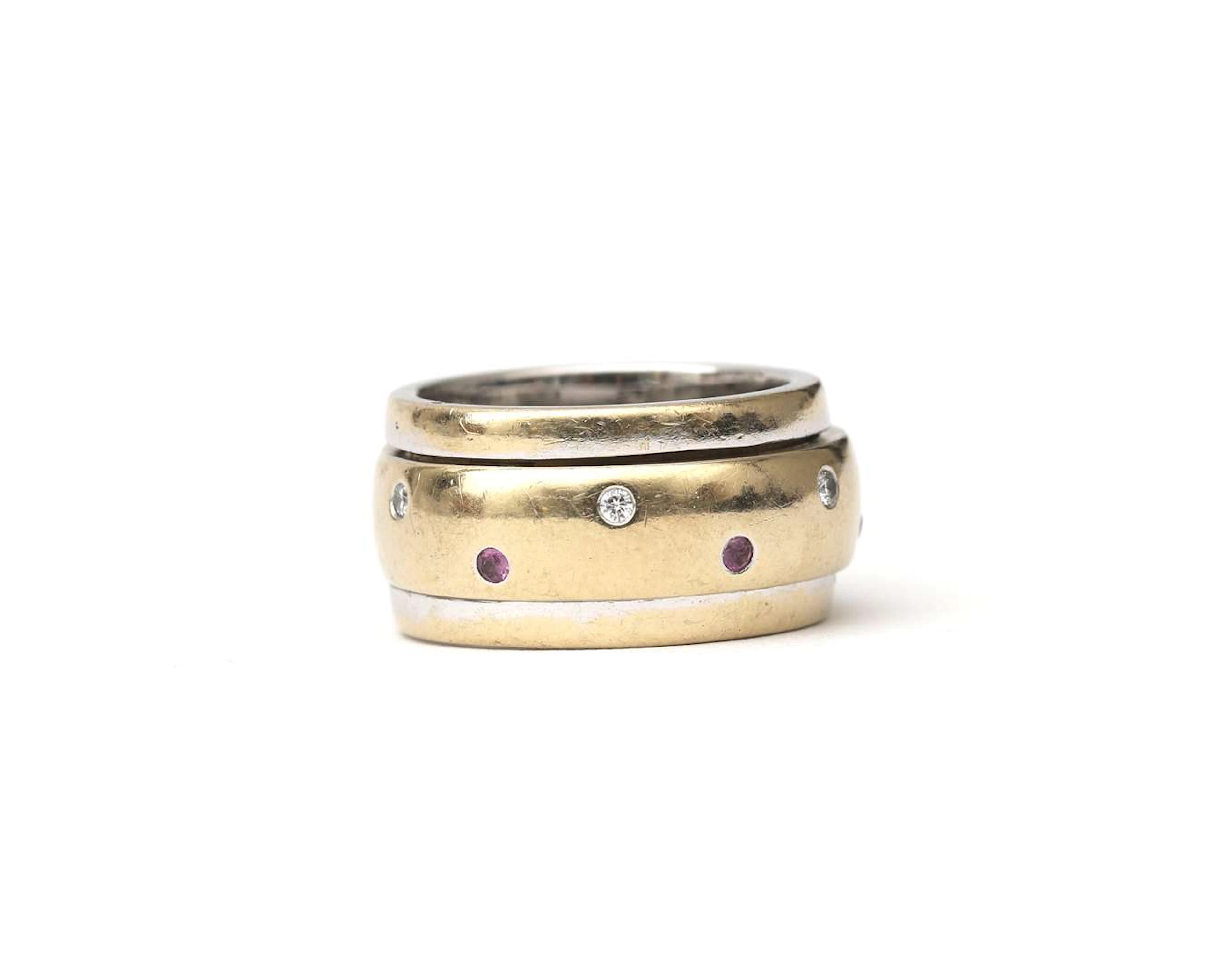 An 18-carat two-tone gold twist ring set with a diamond and a ruby