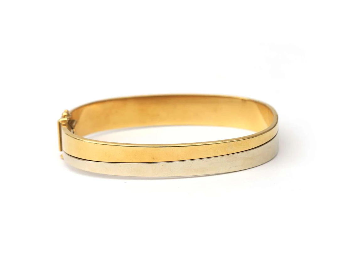 An 18k two-tone gold bangle bracelet, 20th century