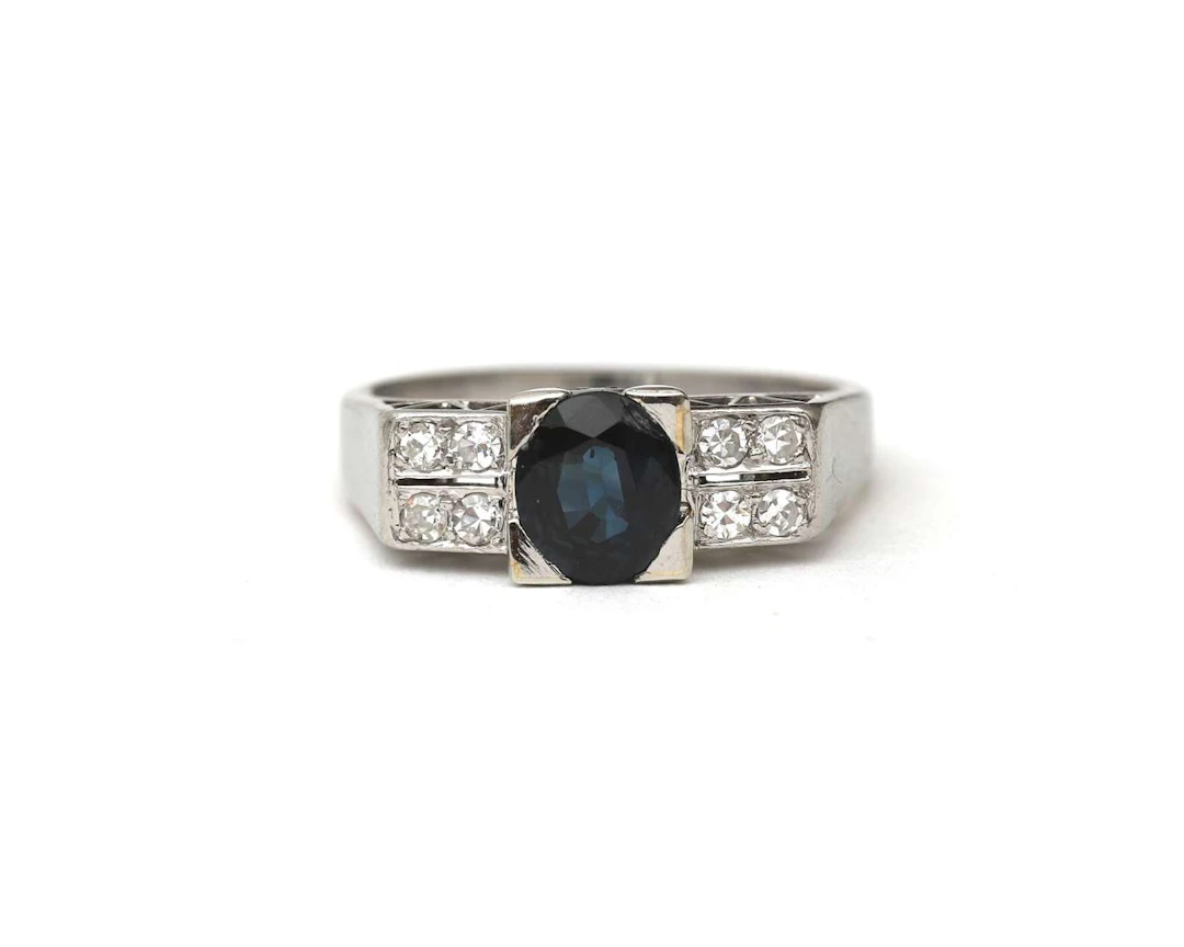 A 14k white gold ring with diamond and sapphire