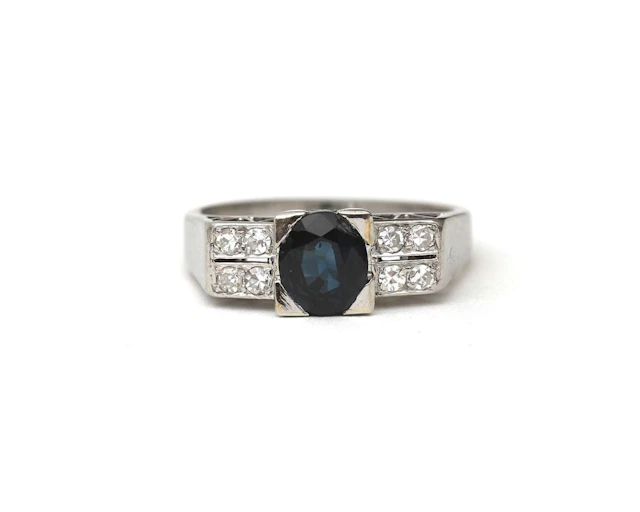A 14k white gold ring with diamond and sapphire