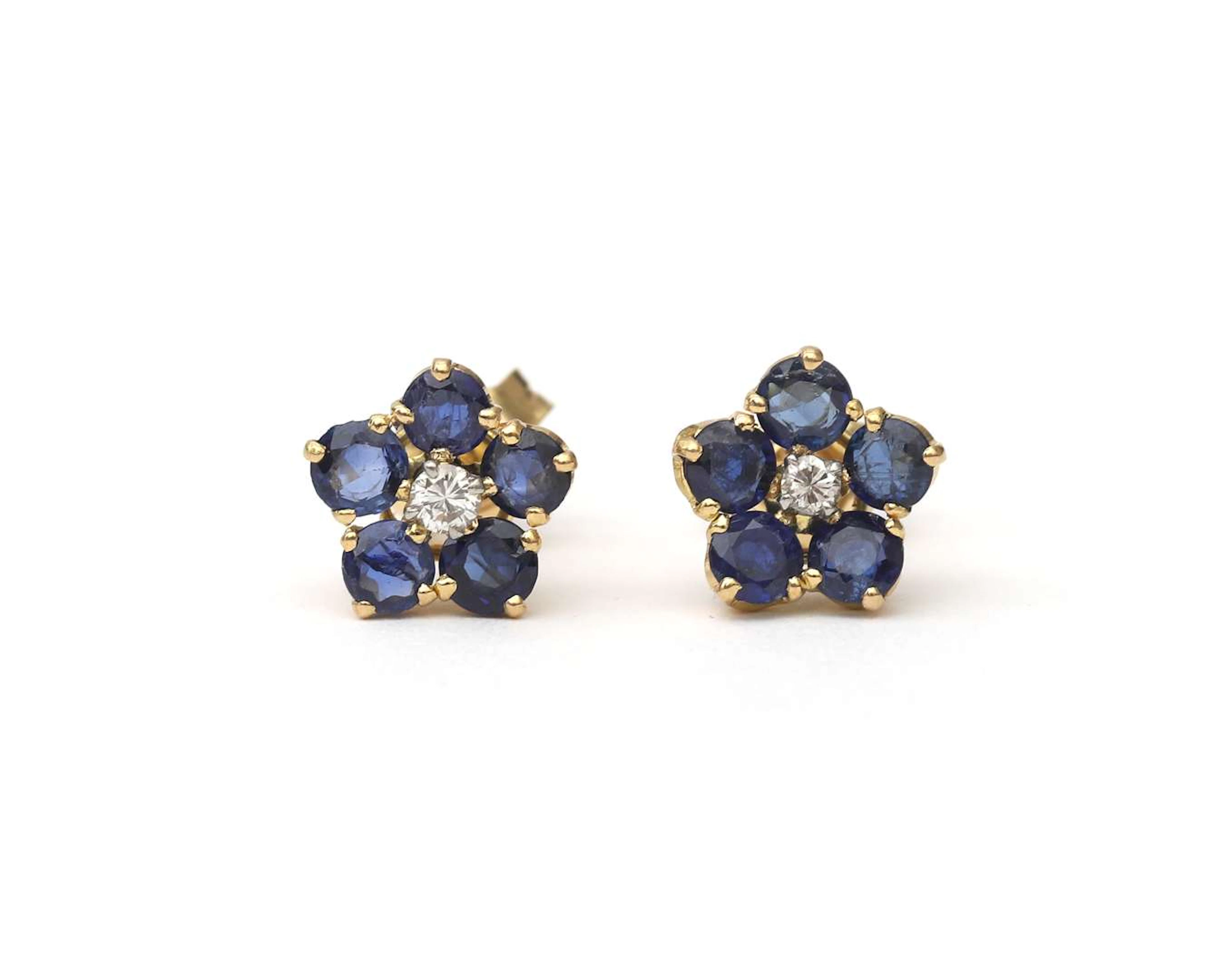 A pair of 18k yellow gold flower earrings set with sapphire and diamond