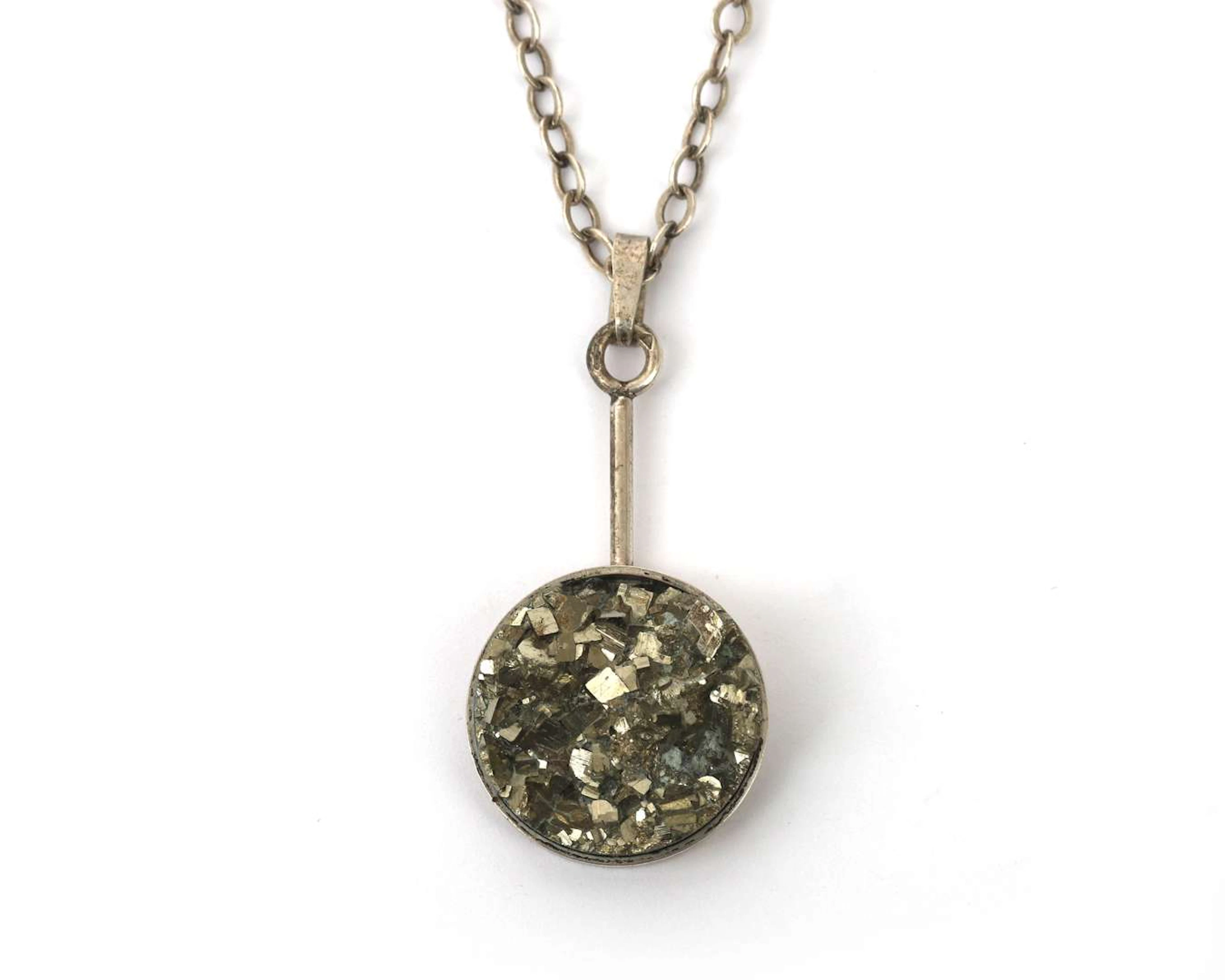 A 2nd grade silver necklace with pendant featuring pyrite crystals