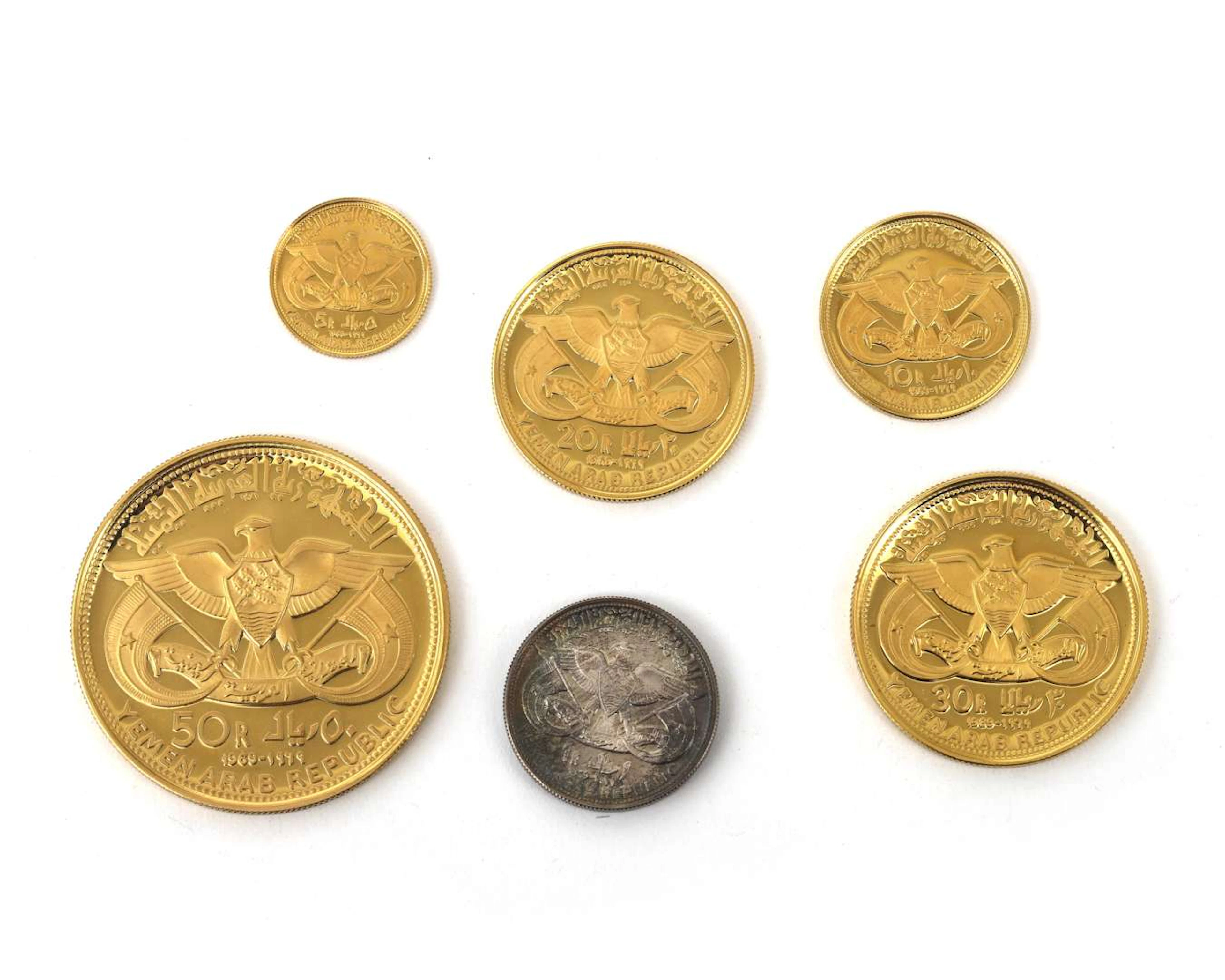 A cassette containing five gold coins and one silver, formerly Arab