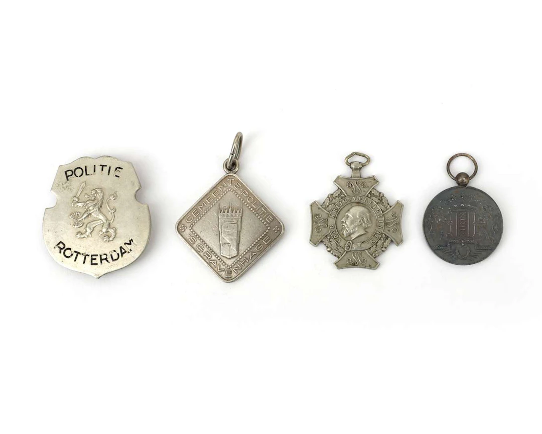Two police badges and a fire brigade badge, the Netherlands, 20th century
