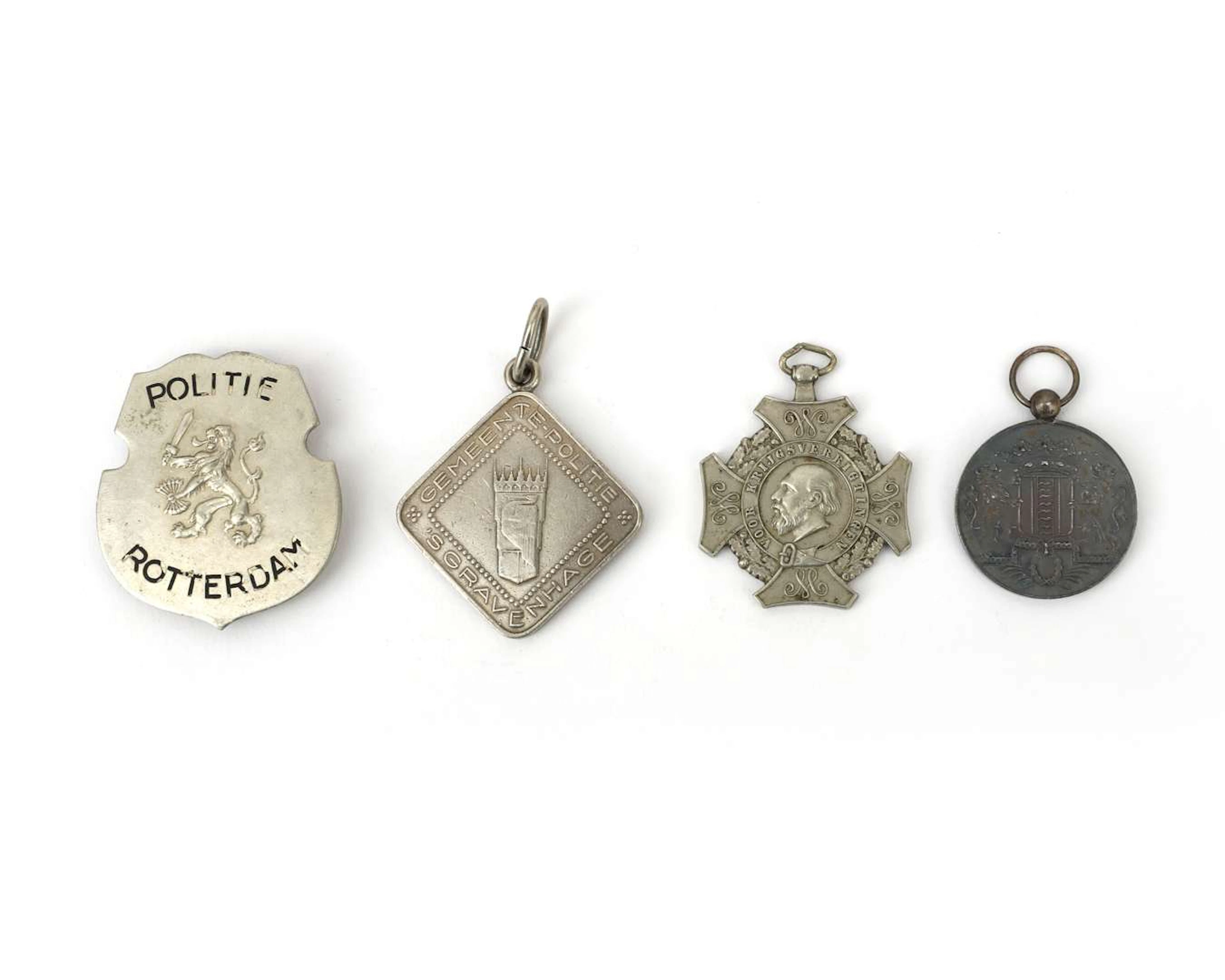 Two police badges and a fire brigade badge, the Netherlands, 20th century
