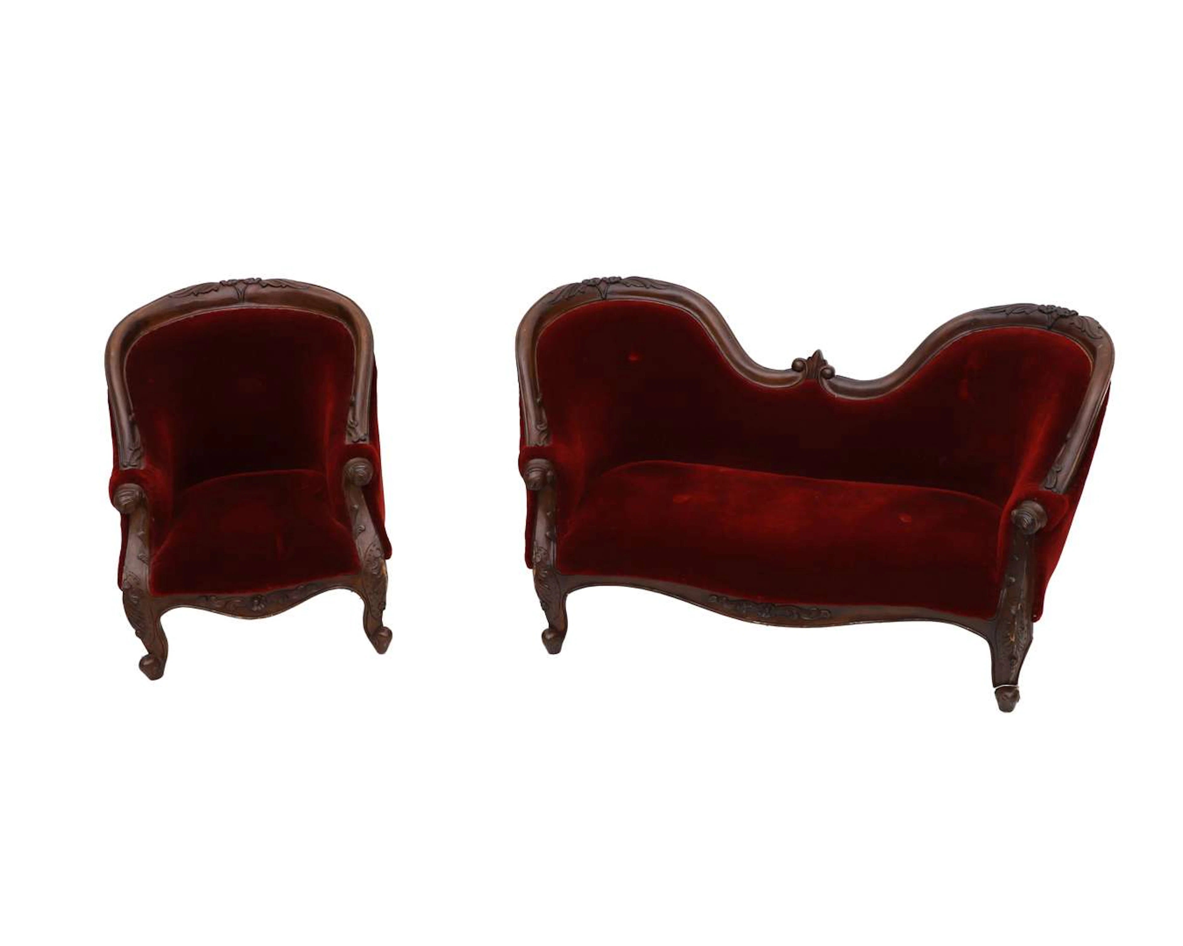 A doll’s sofa and a matching armchair with red upholstery. 20th century