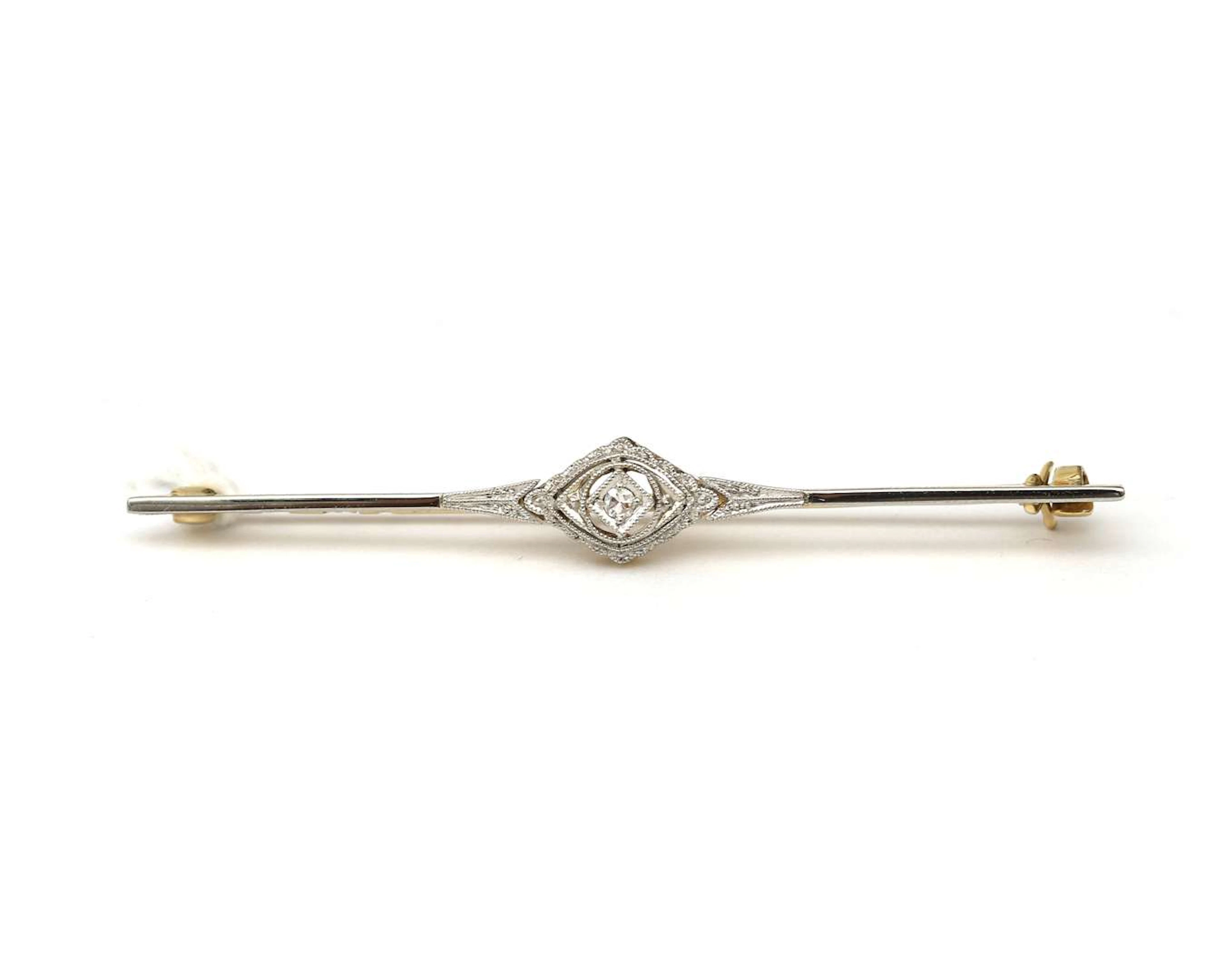 A 14k two-tone gold Belle Époque bar brooch set with a diamond