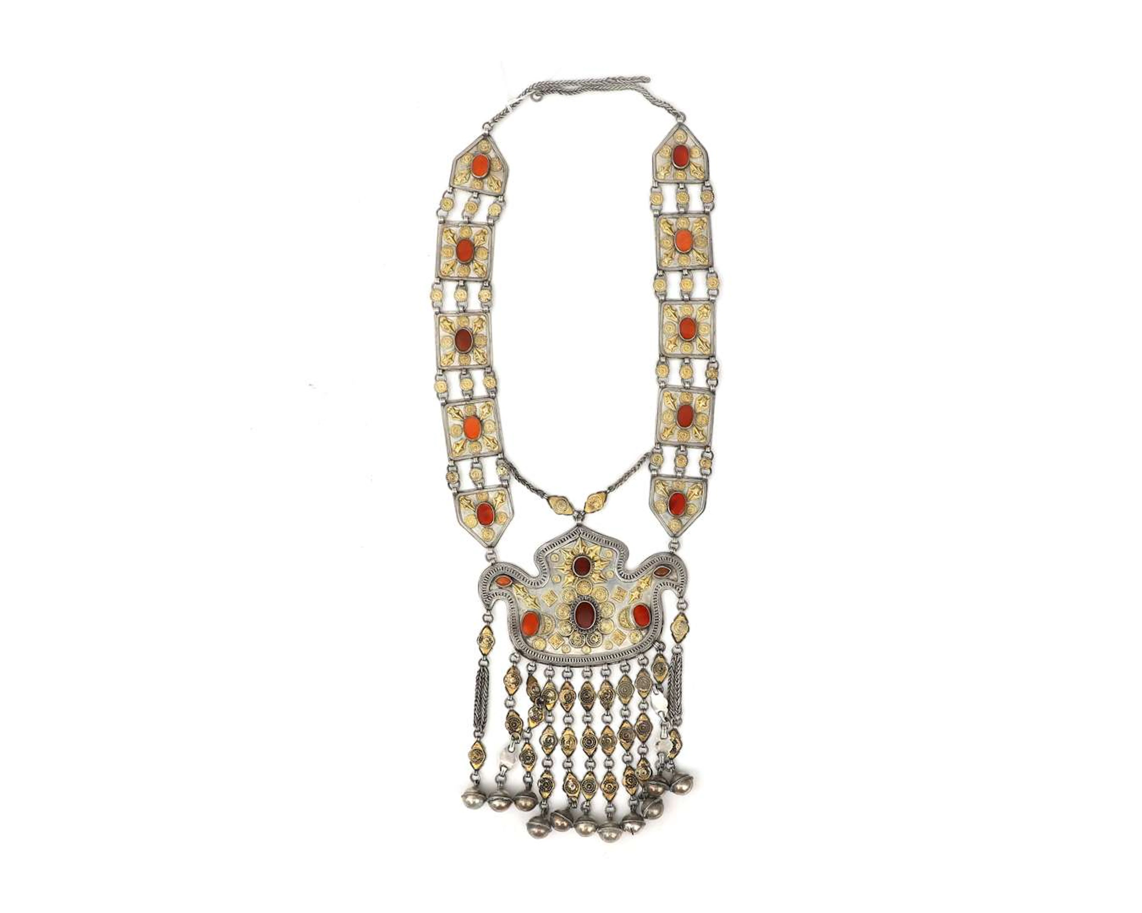 A sterling silver necklace with gold-plated elements and red stones