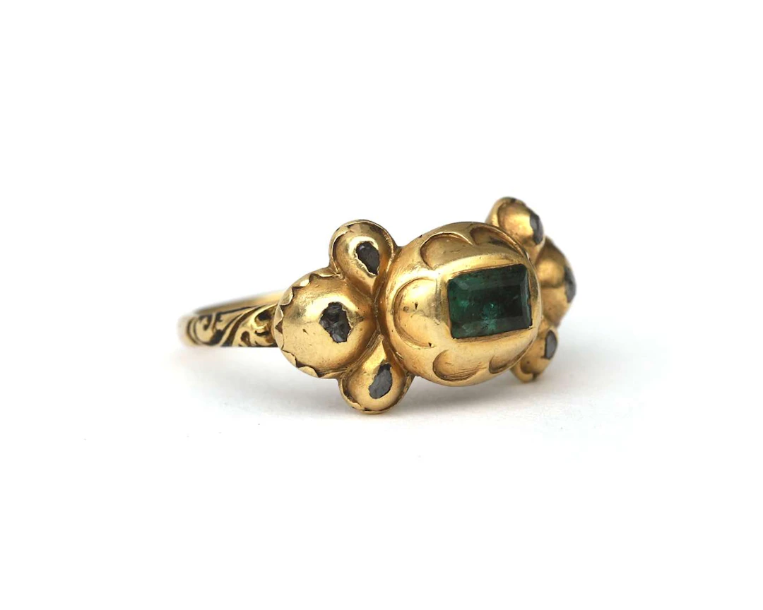 A yellow-gold ring set with an emerald and a diamond, late 17th century