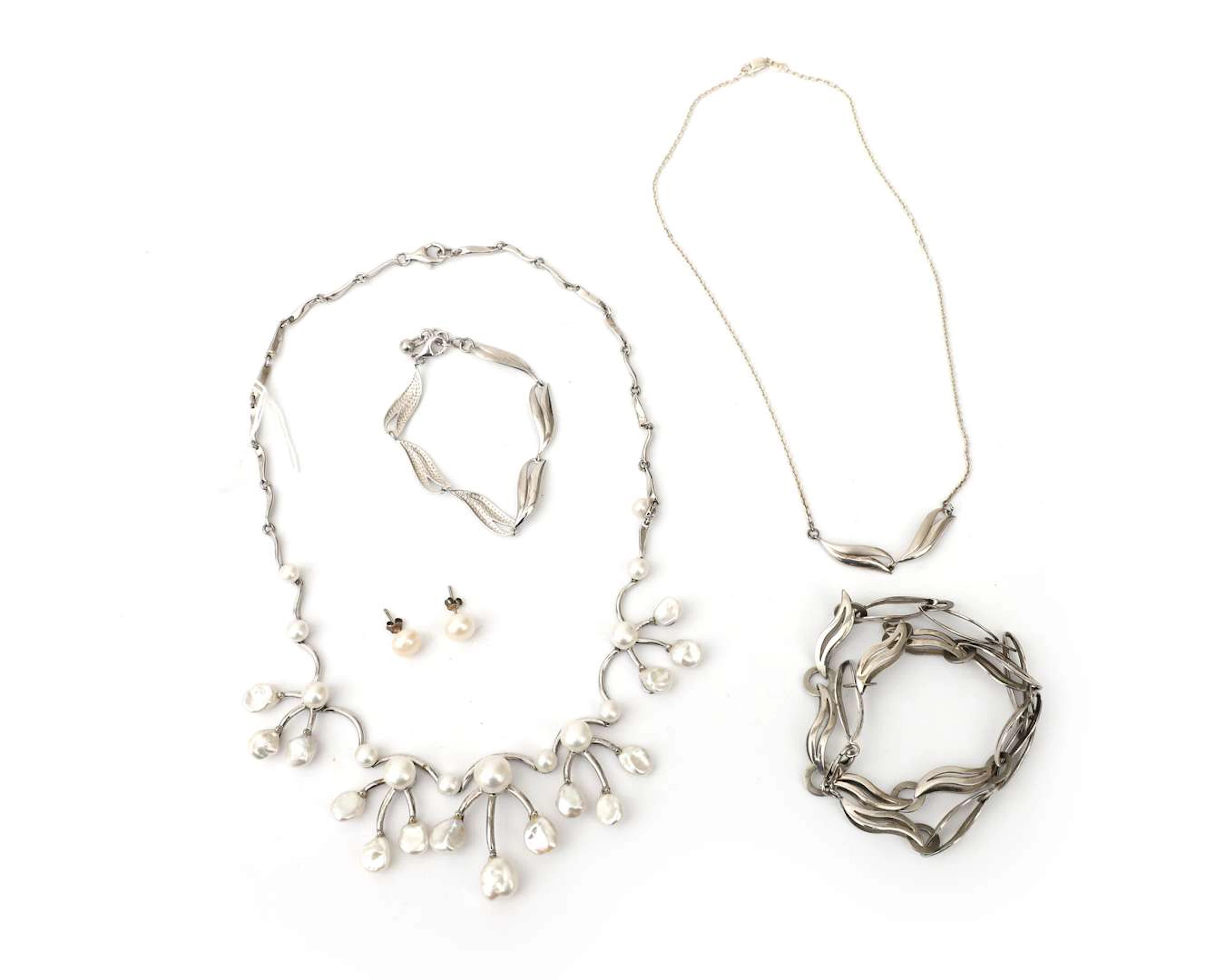 Three sterling silver necklaces, a bracelet and a pair of pearl stud earrings