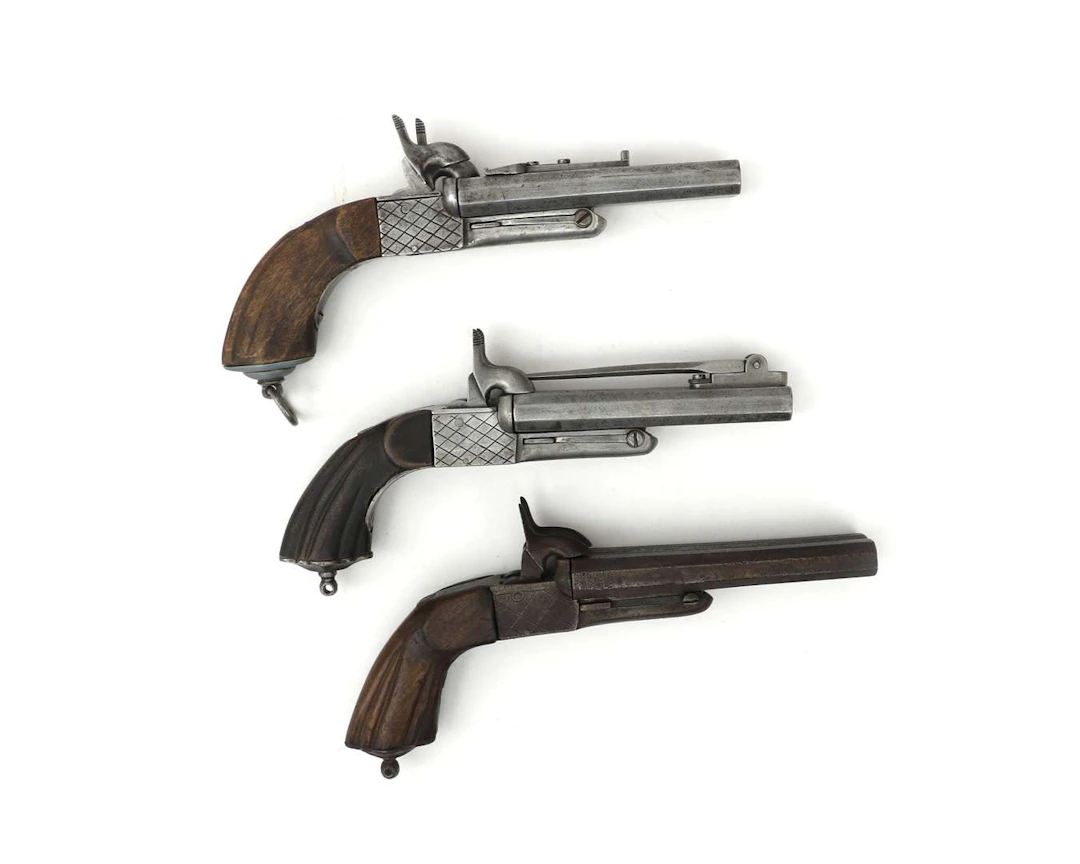 Three double-barrelled rimfire pistols, c. 1900