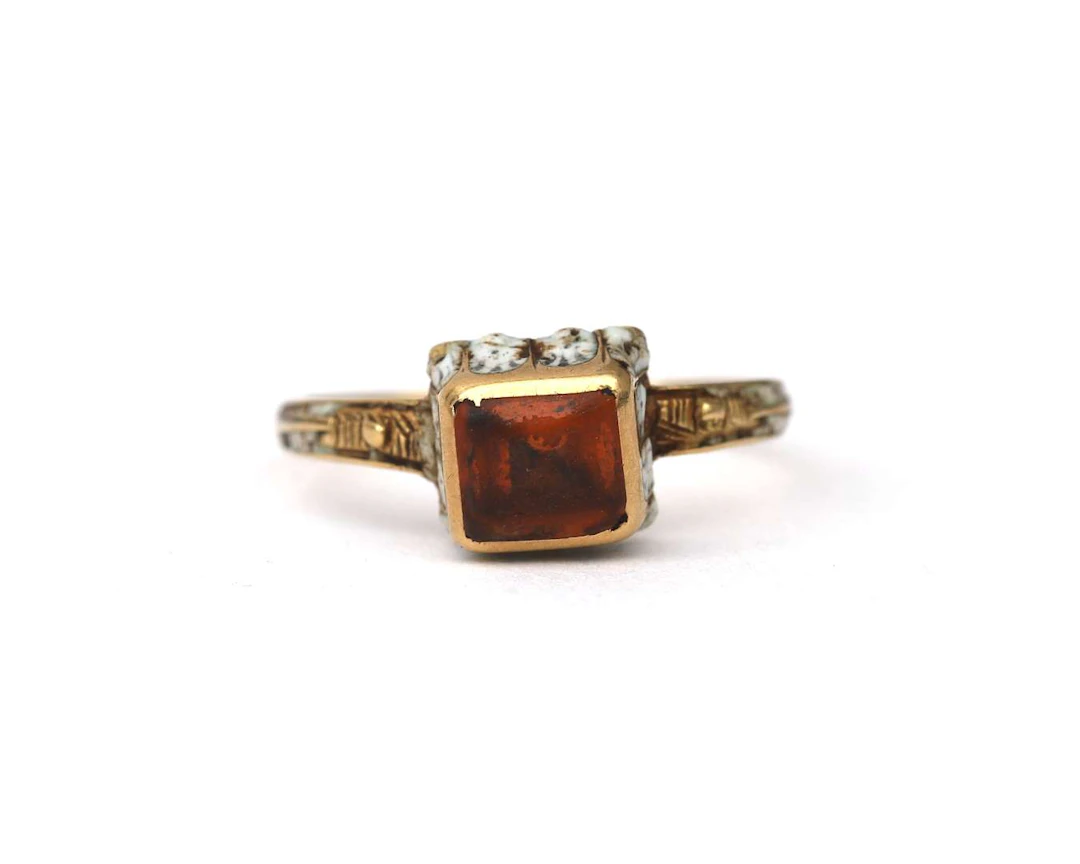 A yellow-gold Renaissance Revival ring set with citrine and enamel