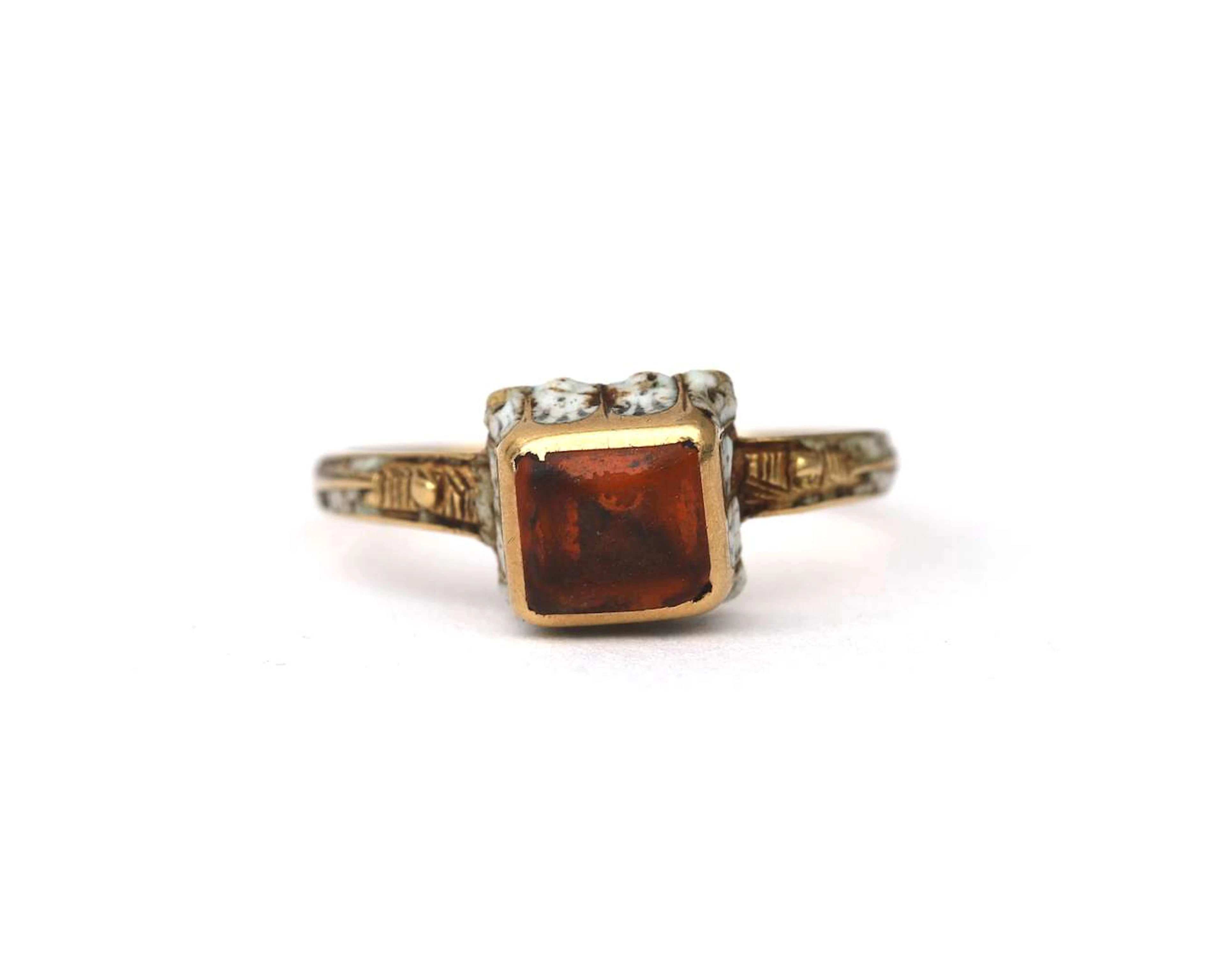 A yellow-gold Renaissance Revival ring set with citrine and enamel