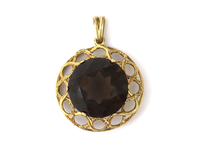 A 14k yellow gold pendant with smoky quartz