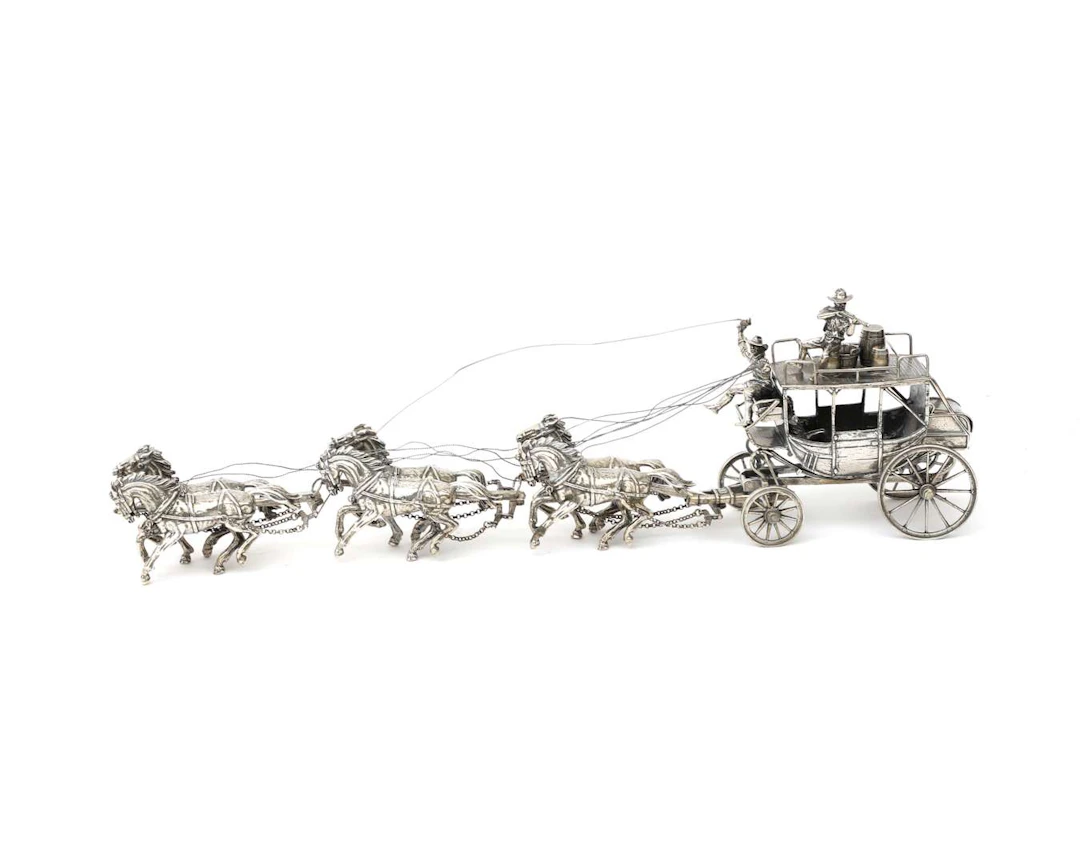 A miniature silver cart with cowboys, 20th century