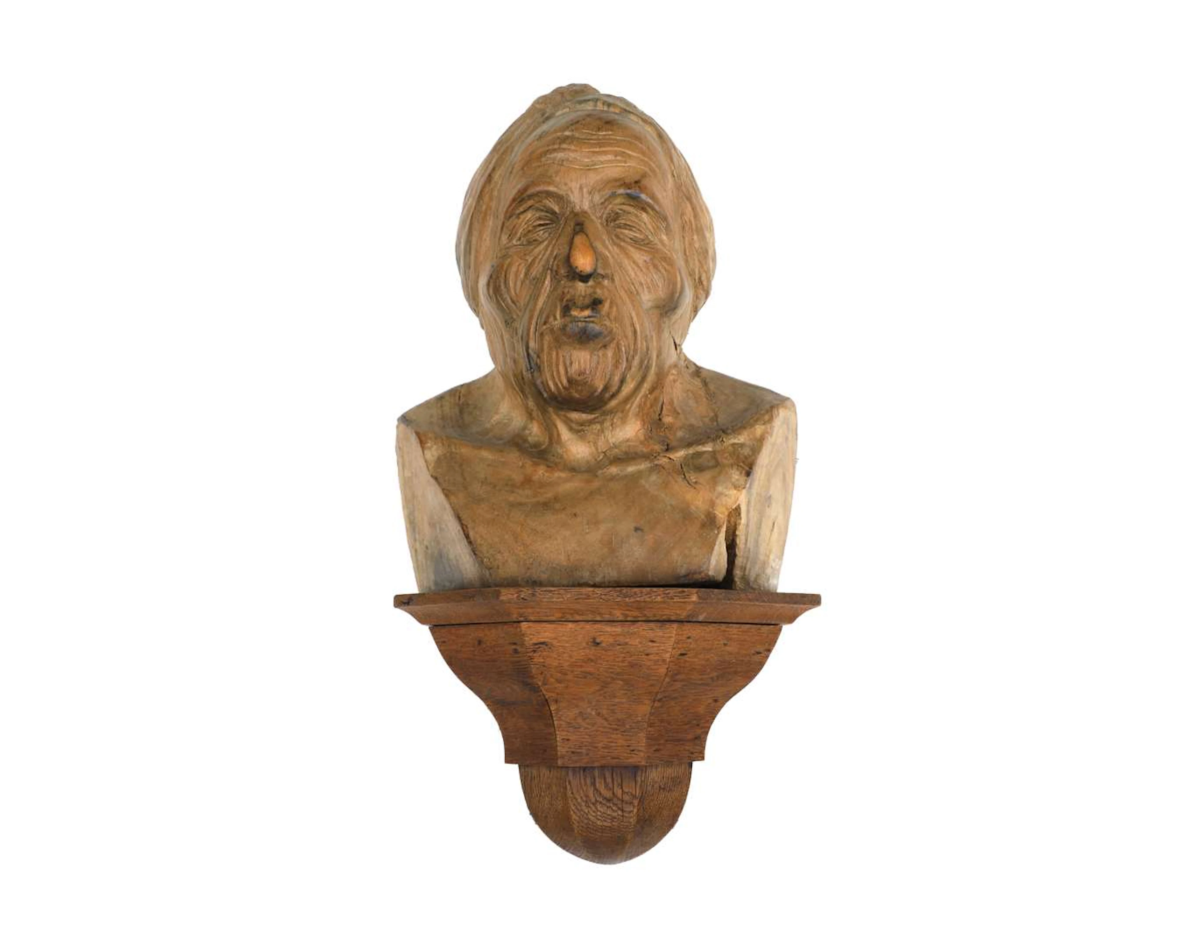 A wooden bust with an oak console, 20th century