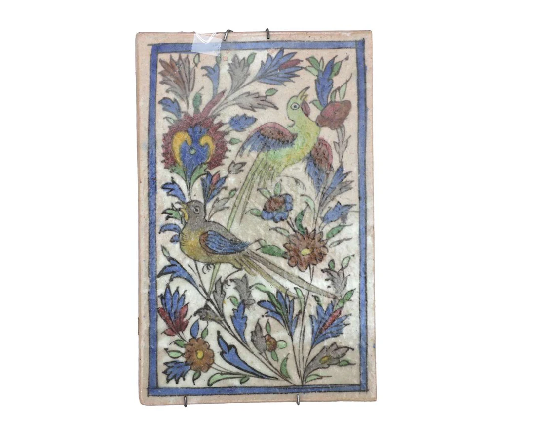 A coloured ceramic tile. Iznik design featuring birds and flowers