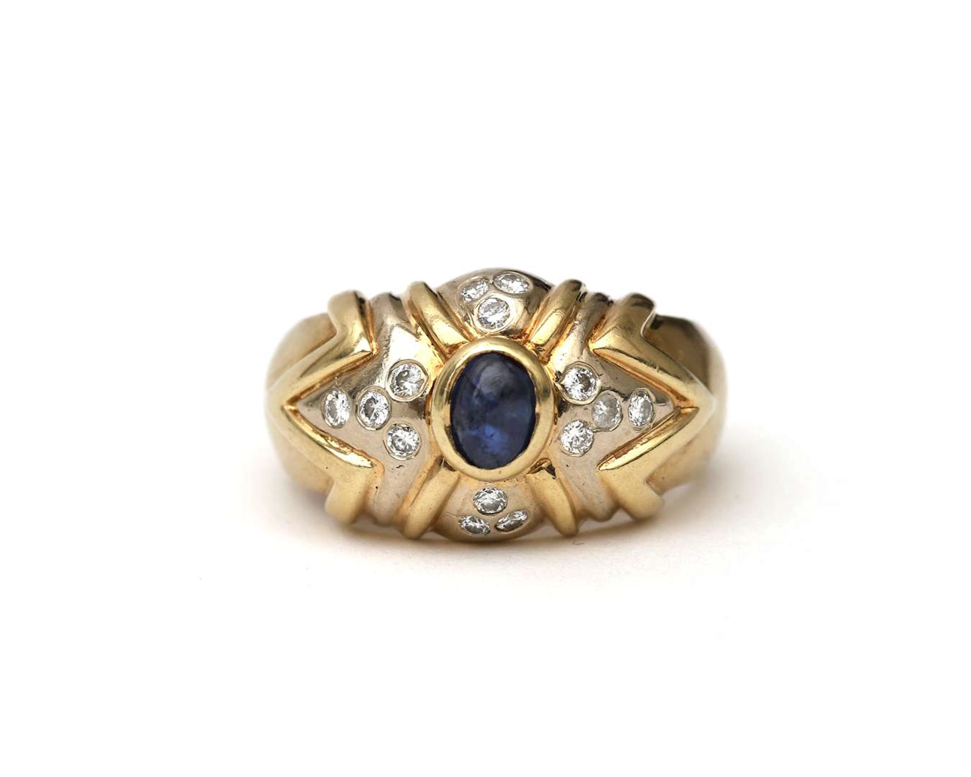 A 14-carat yellow gold domed ring set with a diamond and a sapphire