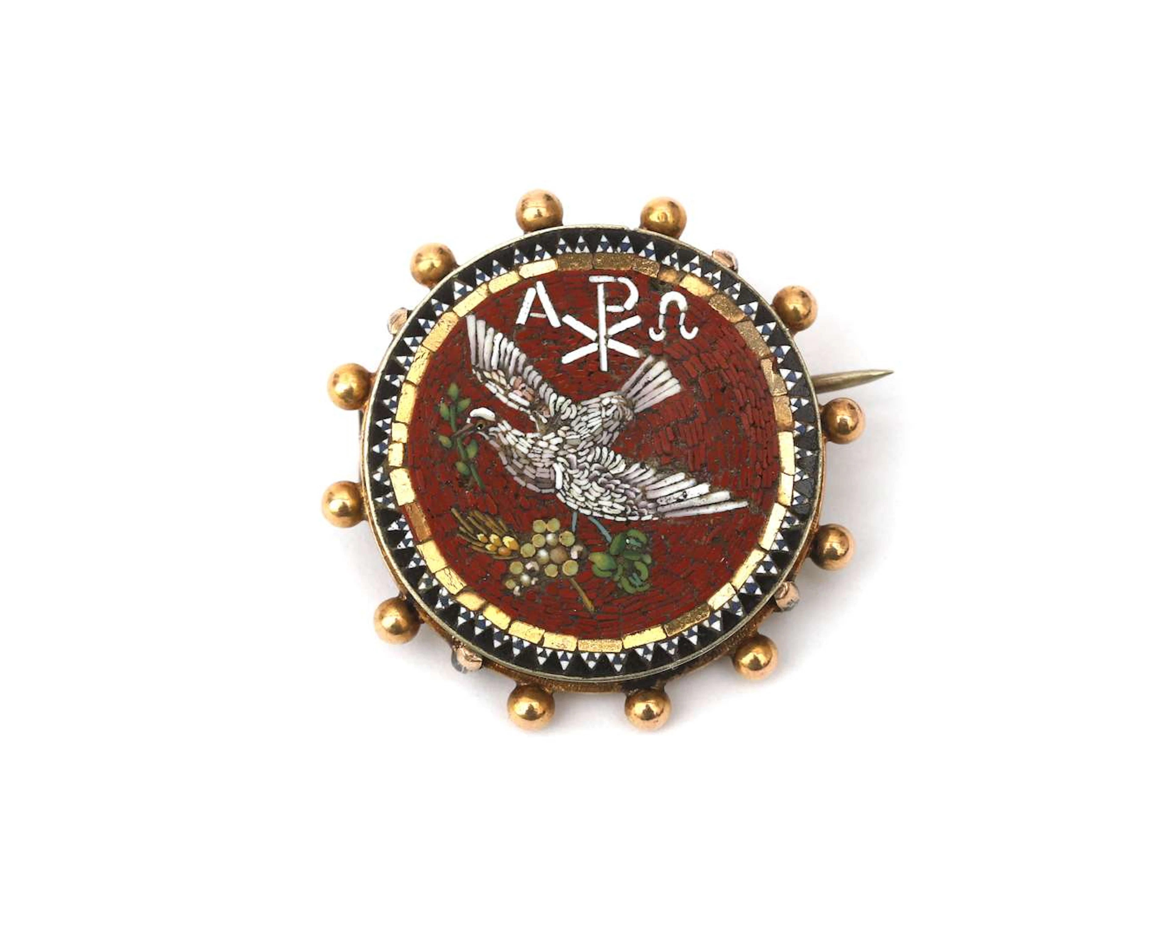 A micro-mosaic brooch featuring a dove of peace with a gold-coloured frame