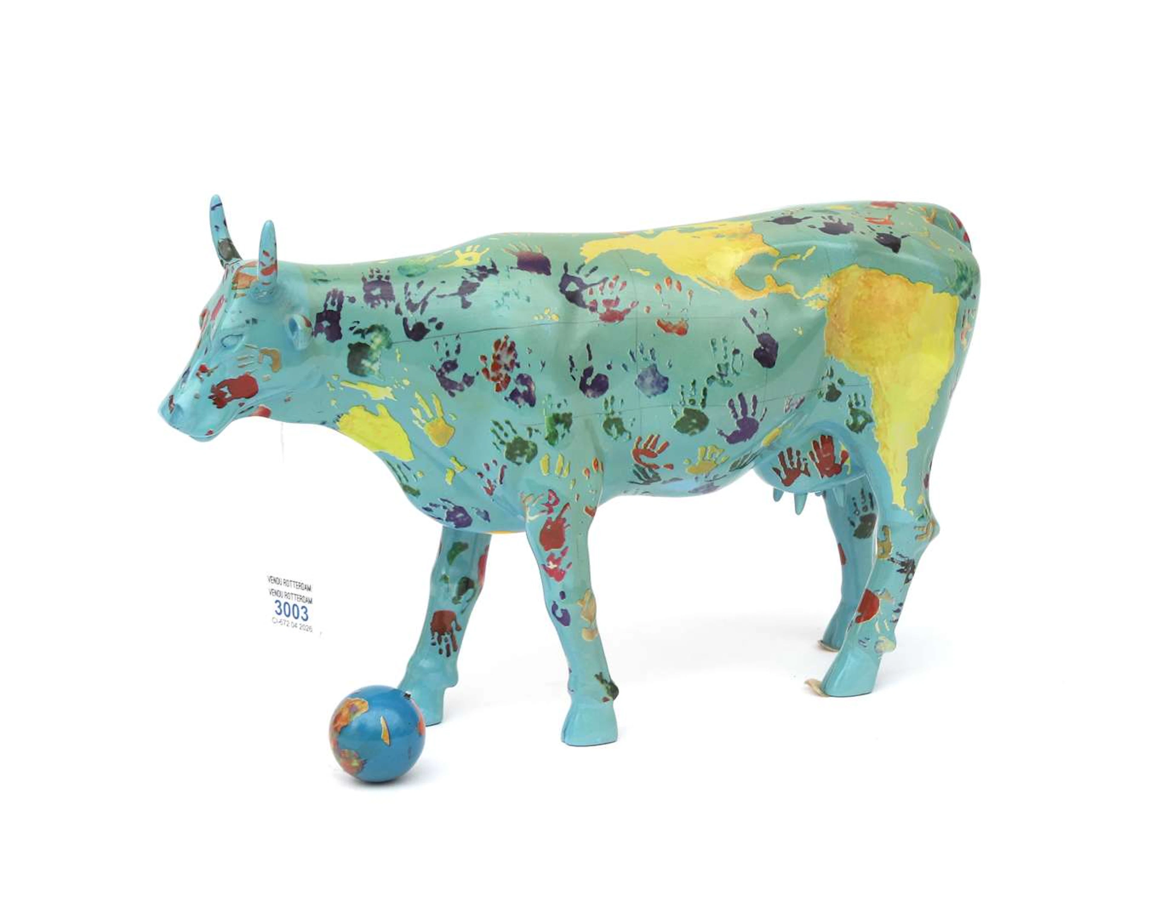 A polyresin sculpture from the cow parade. "It's a smooll world" Design