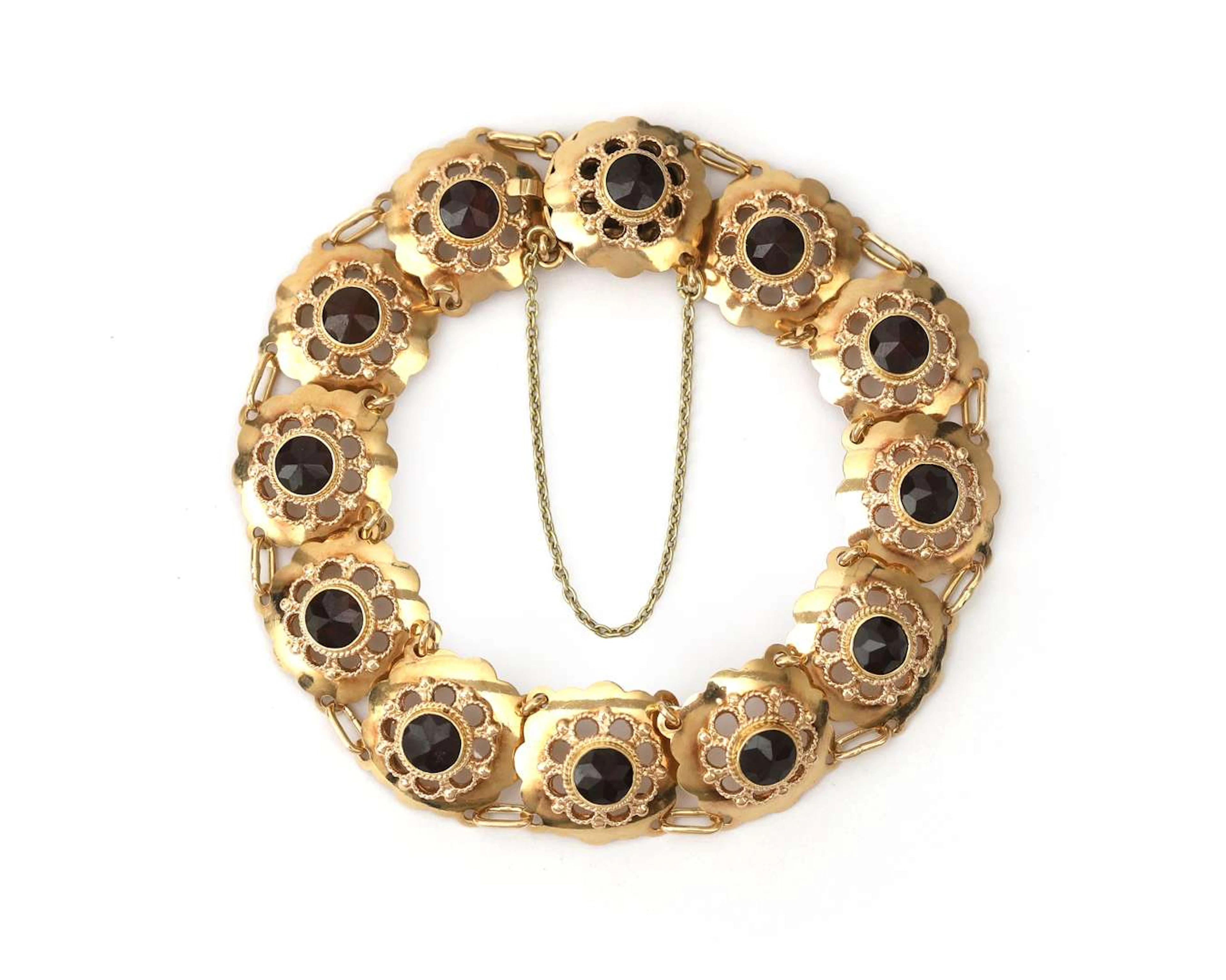 A 14k yellow gold bracelet with garnets