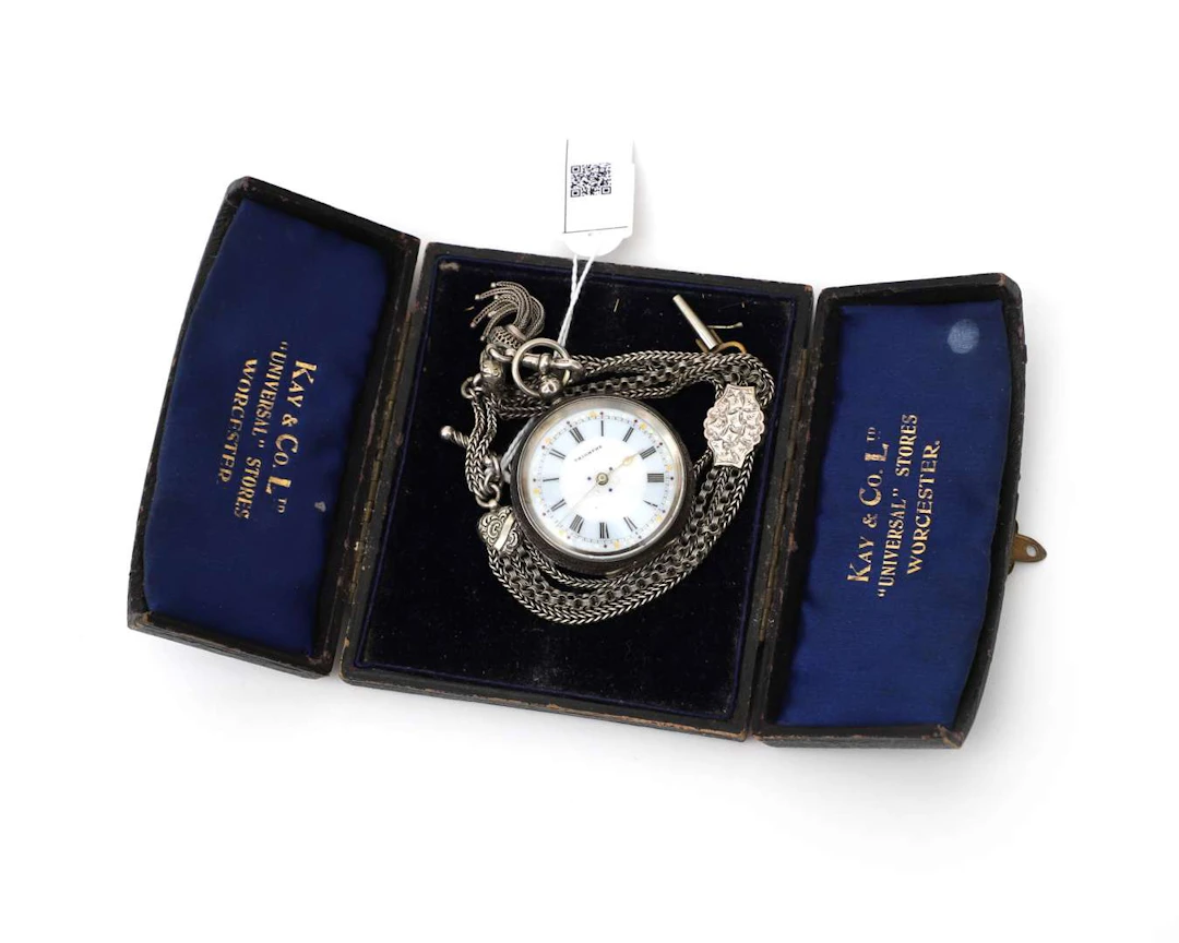 A sterling silver pocket watch with a watch chain