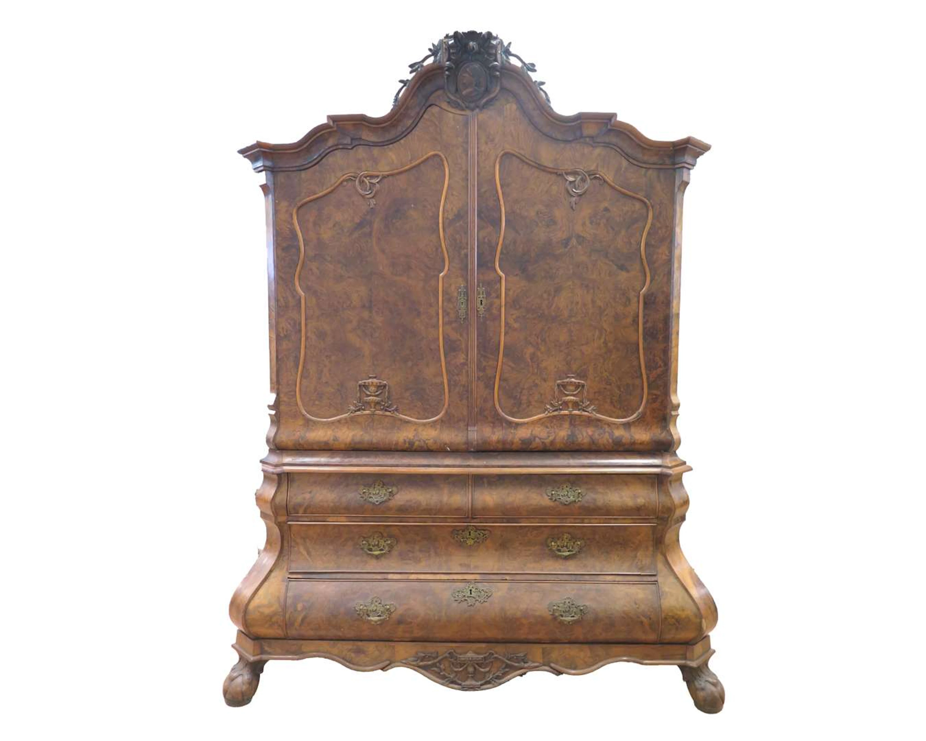 A walnut cabinet with a portrait medallion in the crown. Holland, 18th century