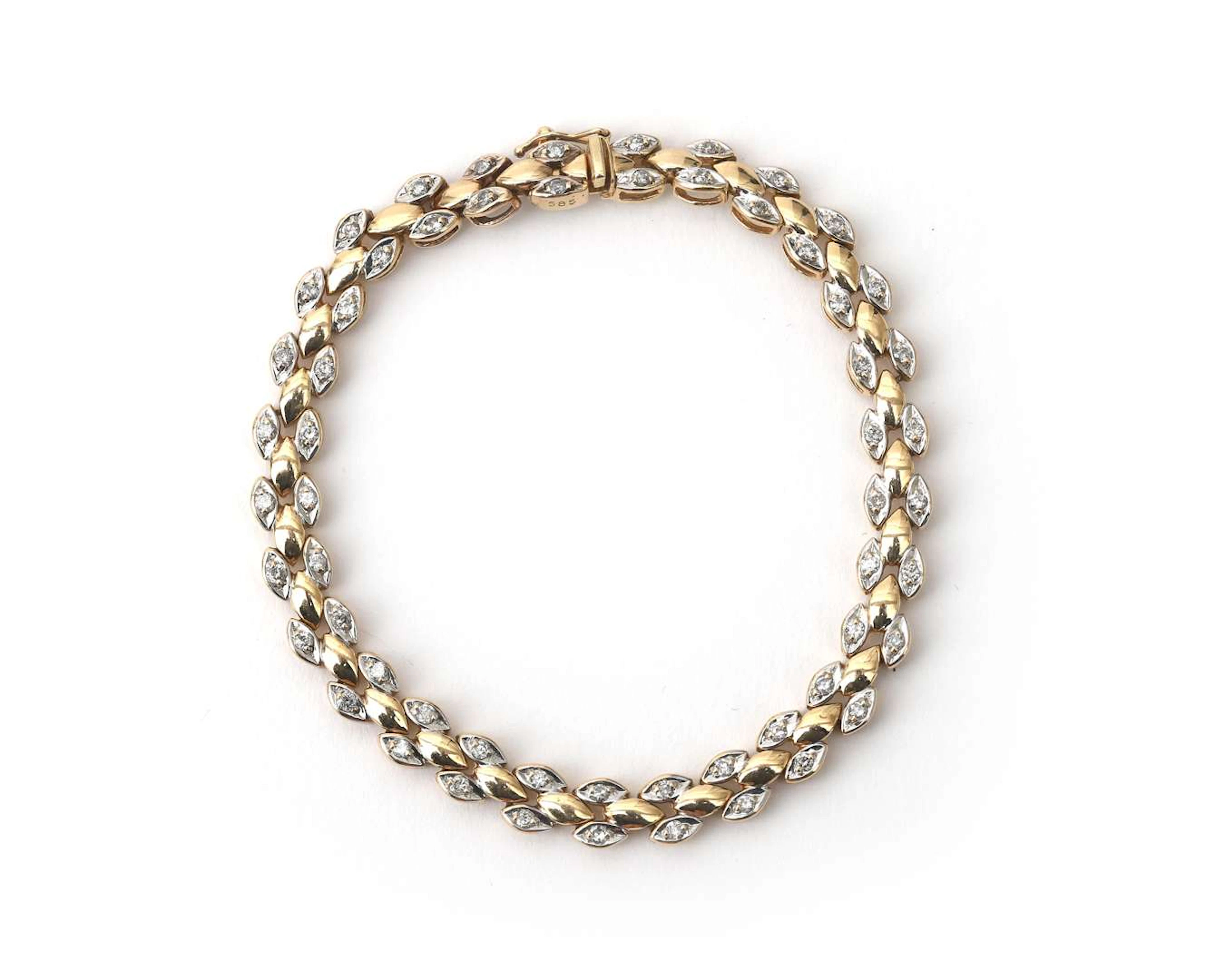 A 14k two-tone gold link bracelet with a diamond
