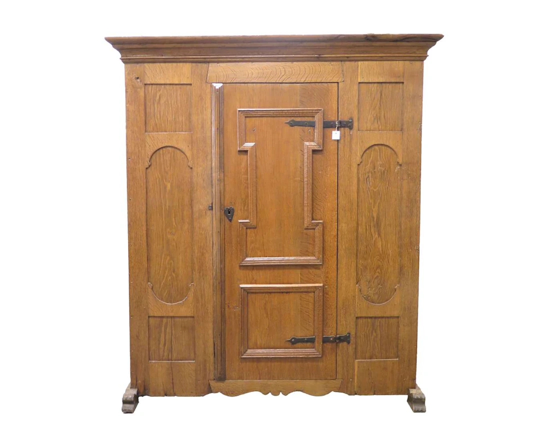 An oak single-door cupboard on legs. 18th century