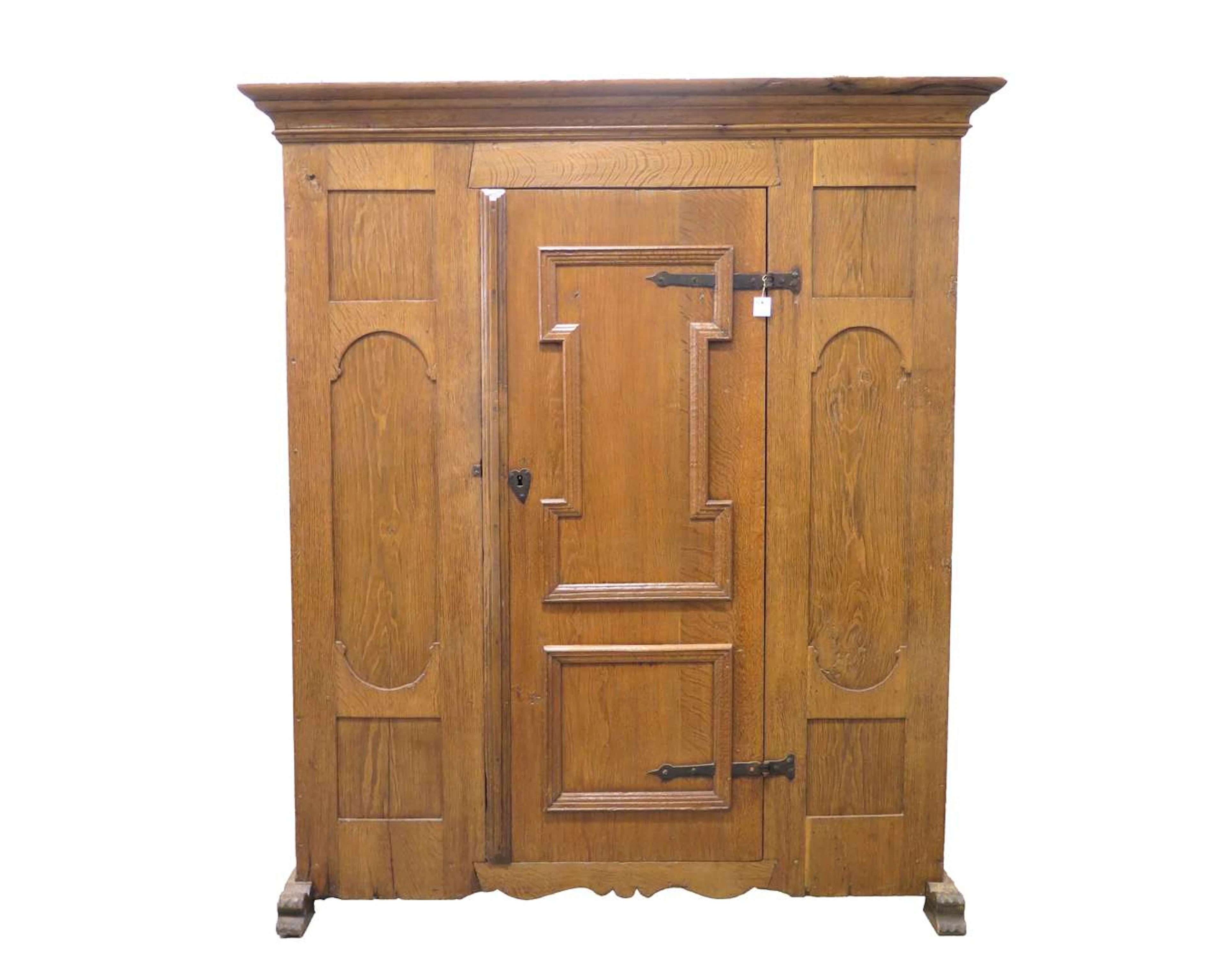 An oak single-door cupboard on legs. 18th century