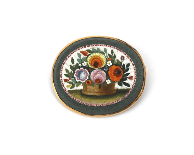 A 14k yellow gold oval brooch with a micro-mosaic