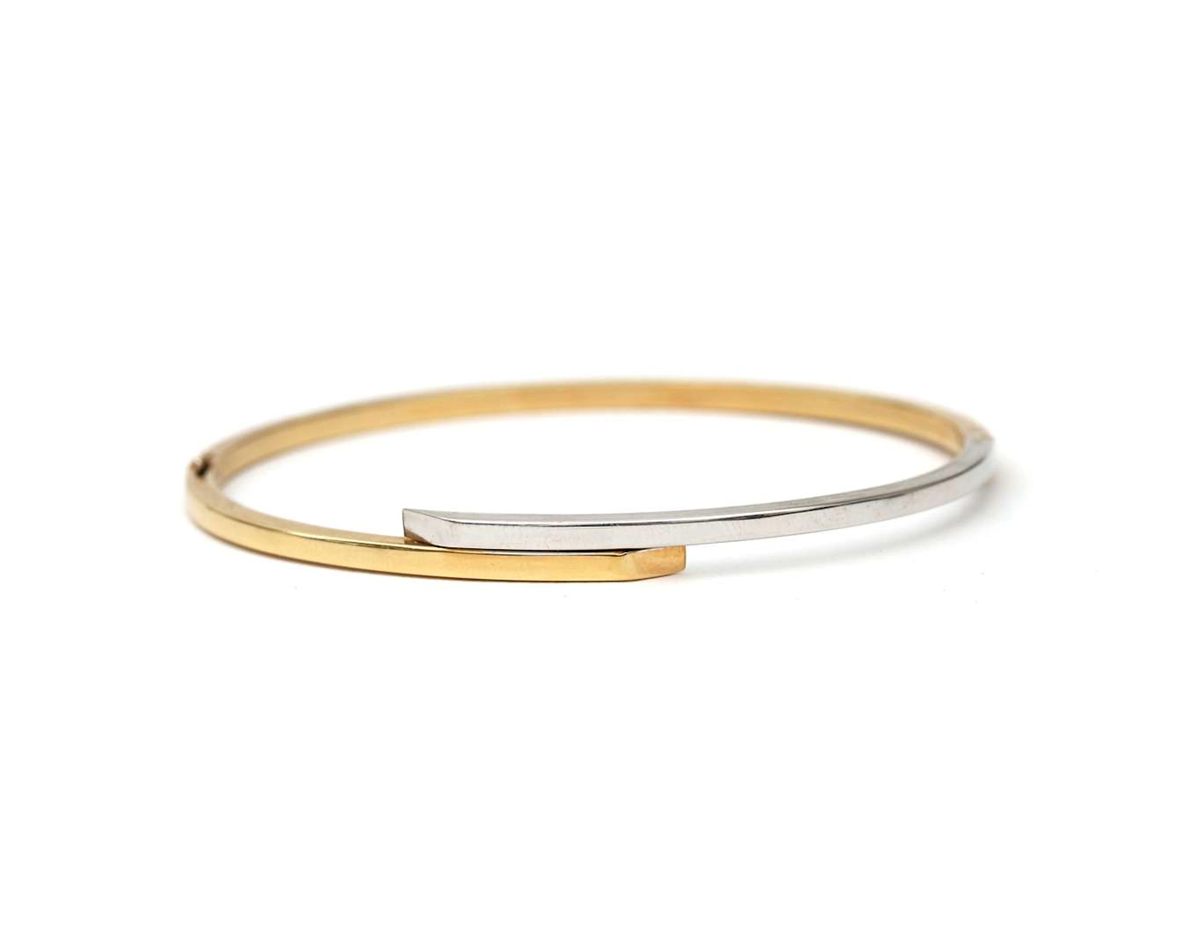 A 14-carat two-tone gold bangle bracelet
