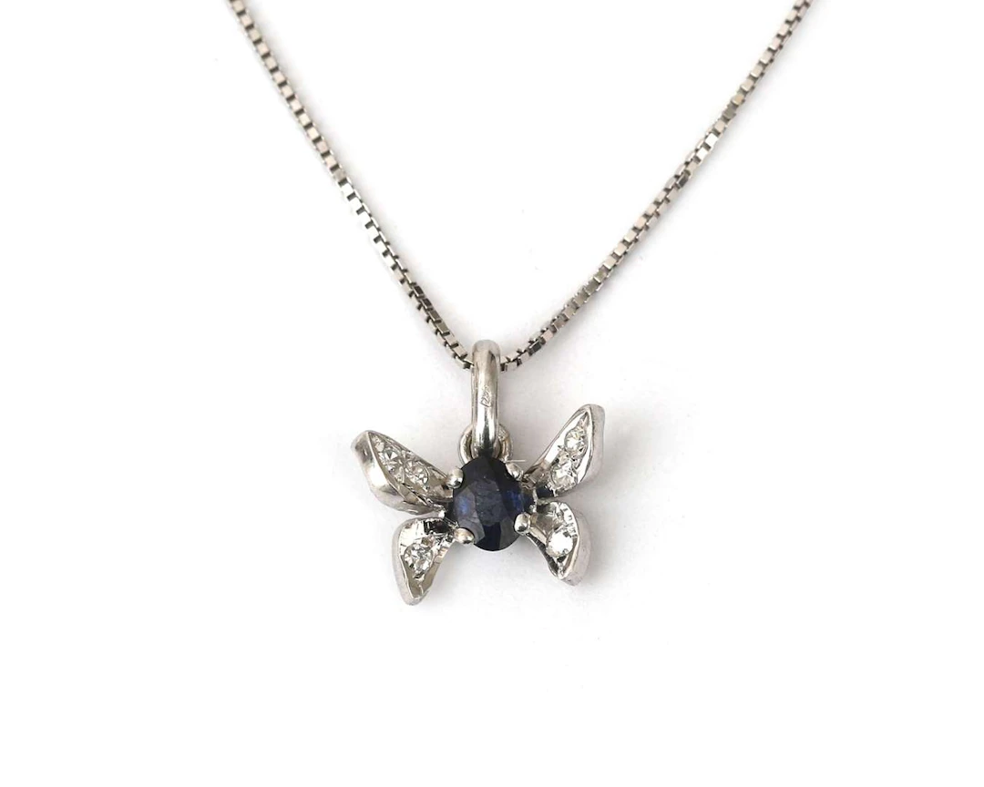 An 18-carat white gold necklace with a butterfly pendant set with
