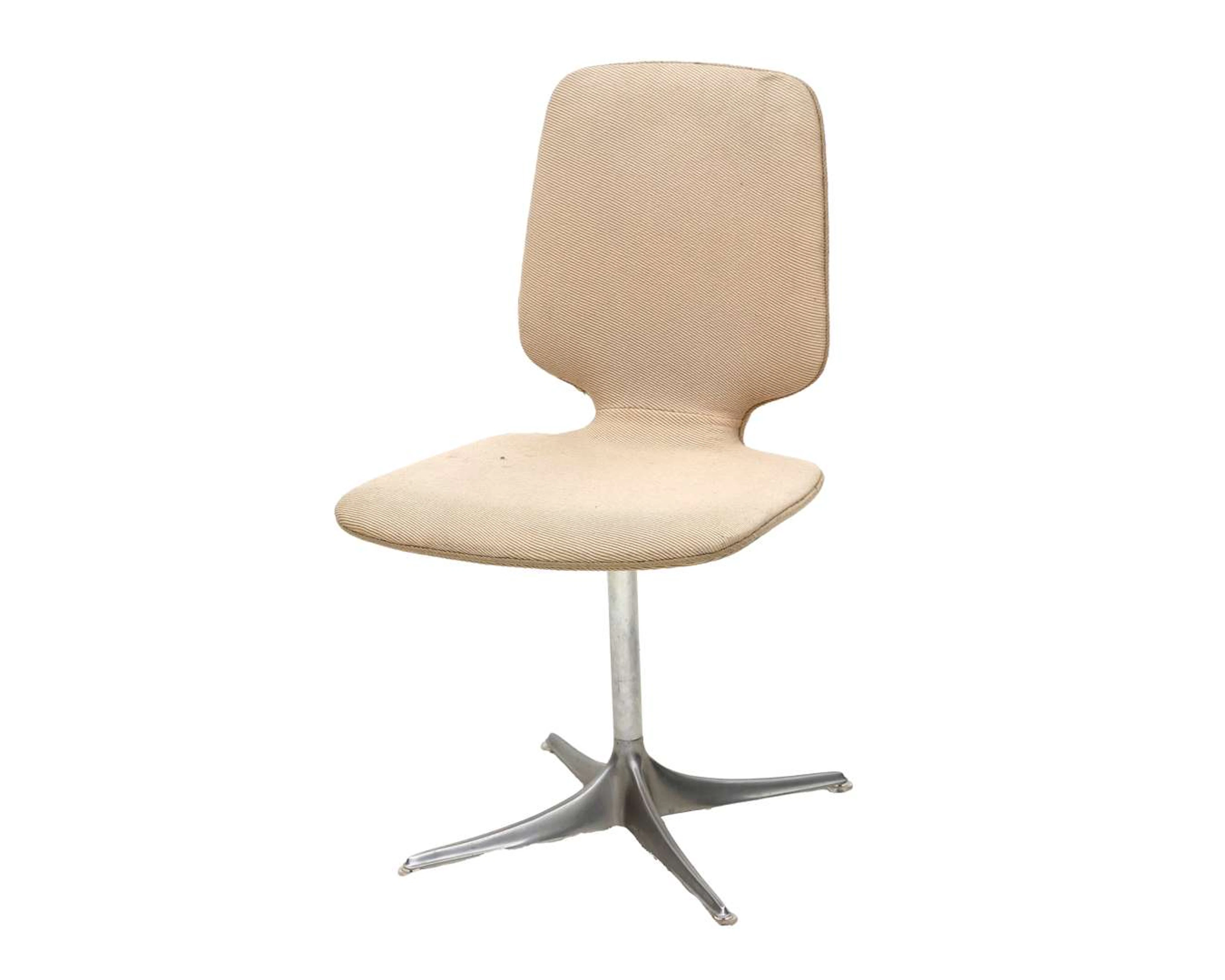 A cream-coloured upholstered chair, designed by Horst Brüning, produced