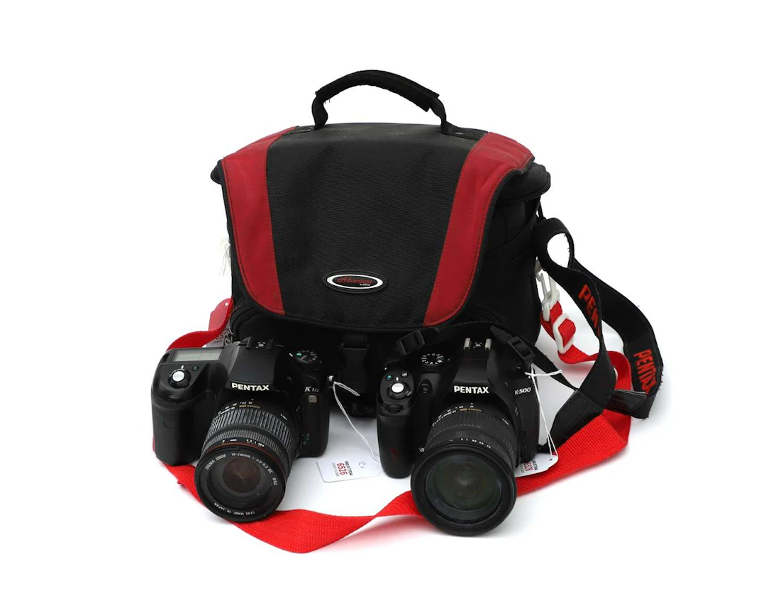 Two Pentax digital single-lens reflex cameras, namely the Pentax K10D