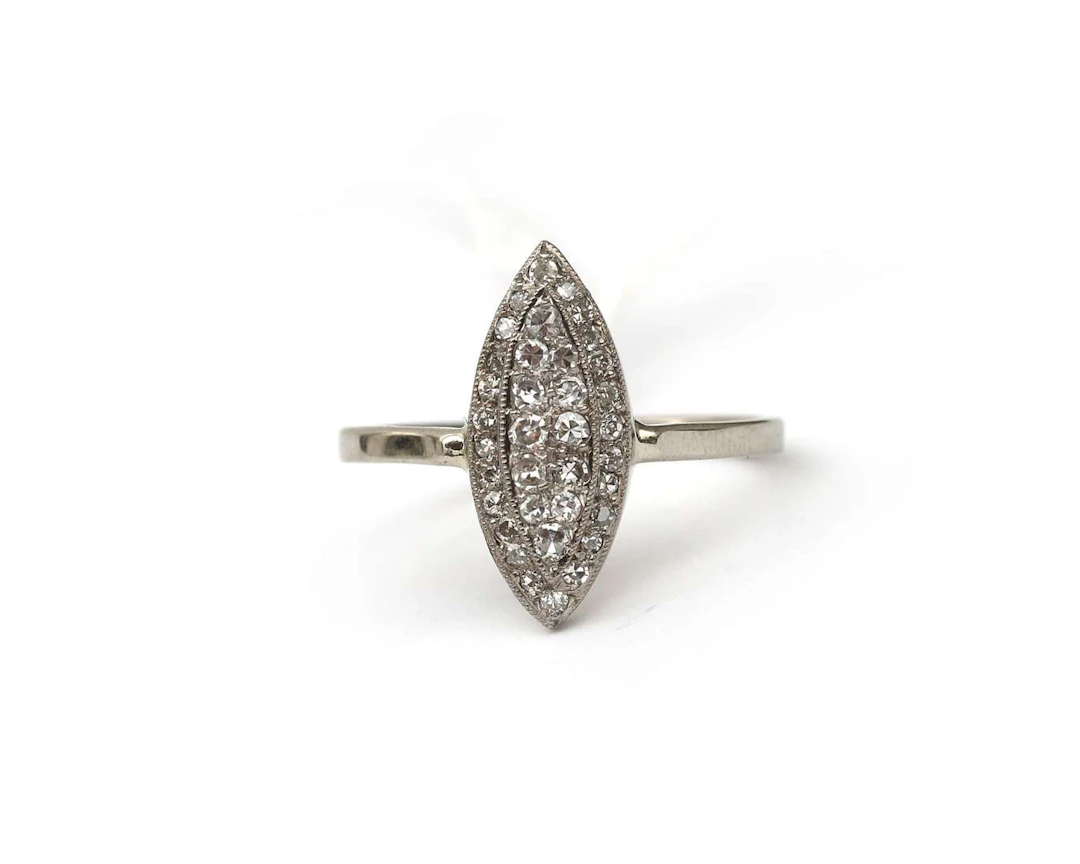 A 14k white gold navette ring with diamonds