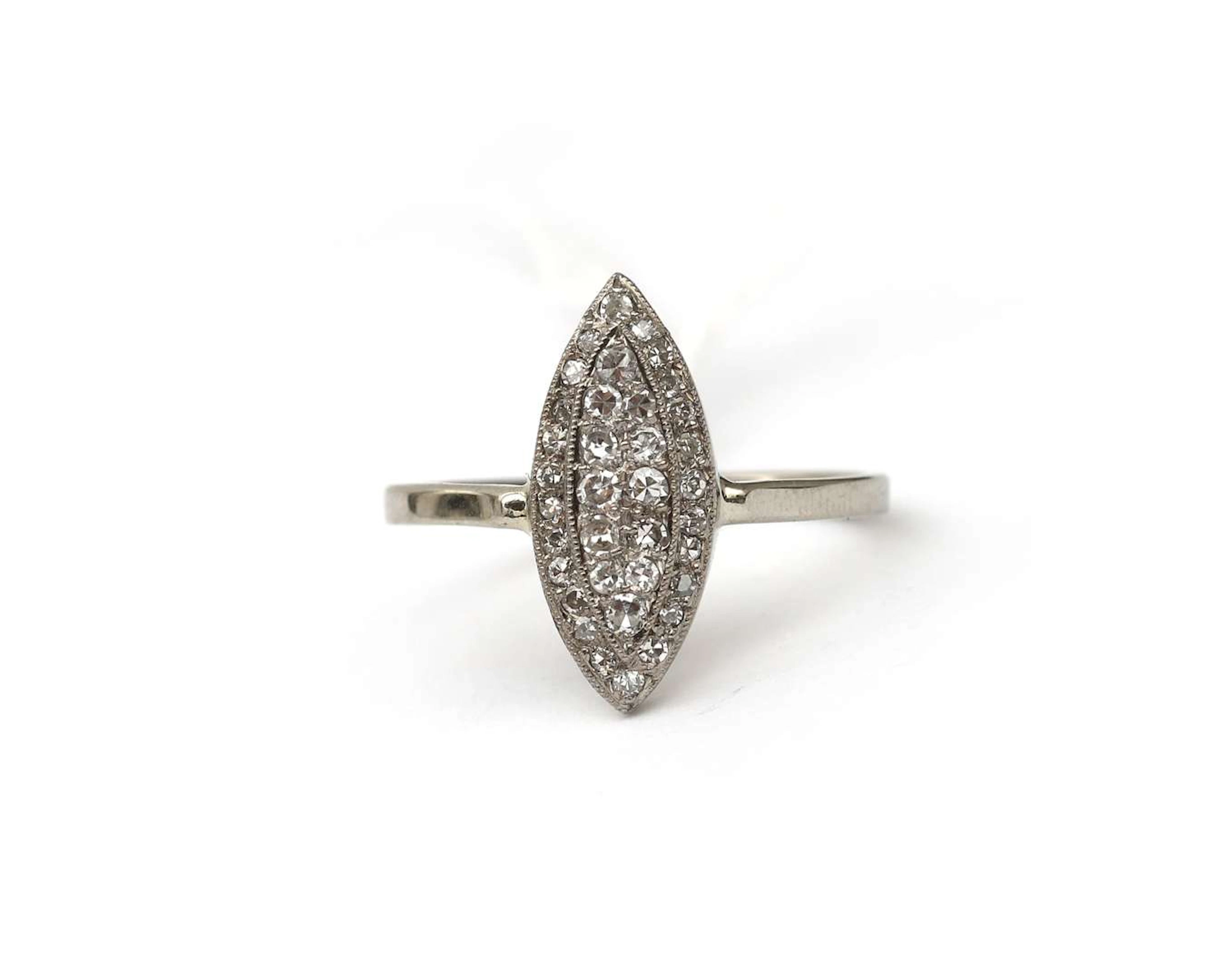 A 14k white gold navette ring with diamonds