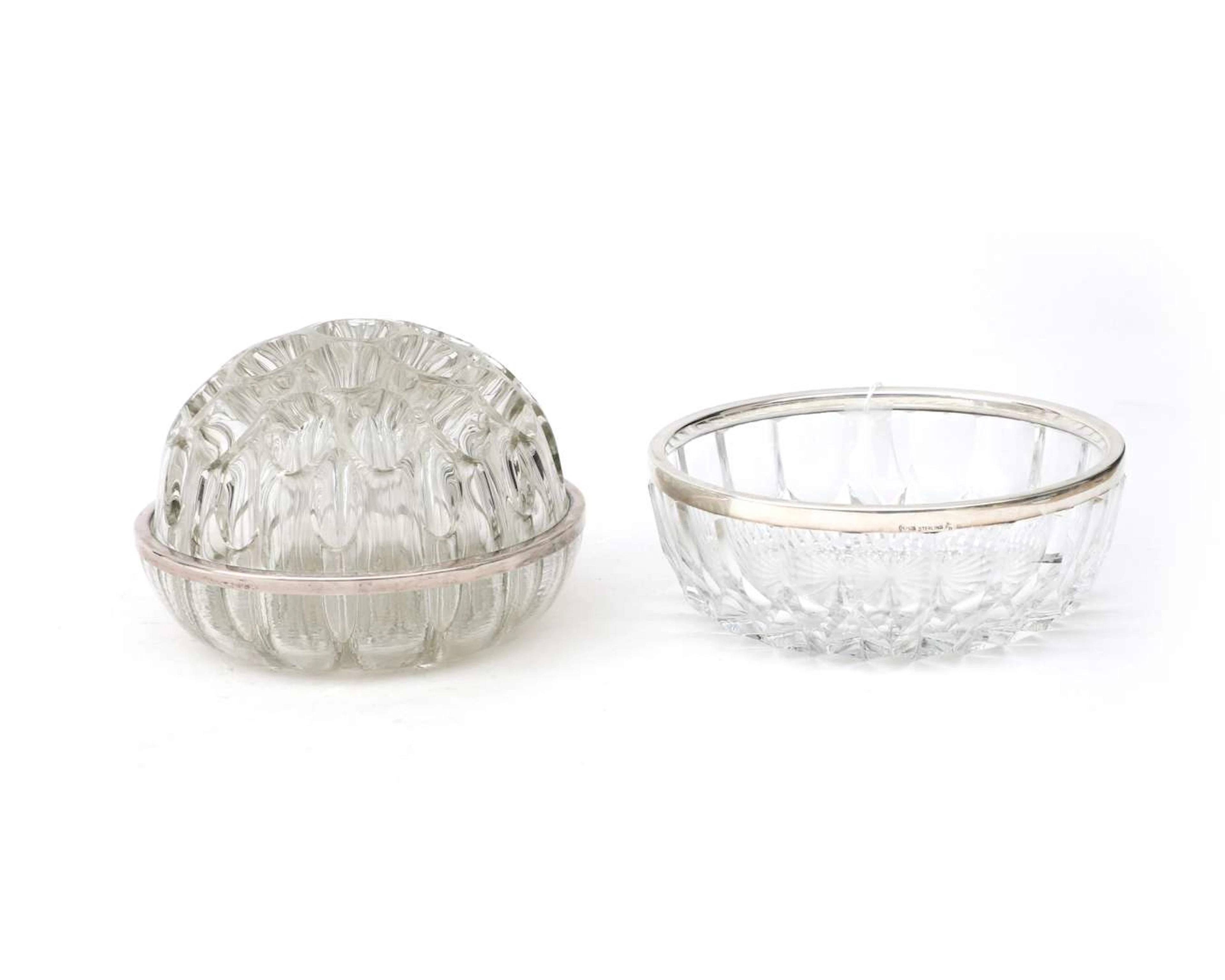 A glass flower vase with a first-grade silver rim and a bowl with
